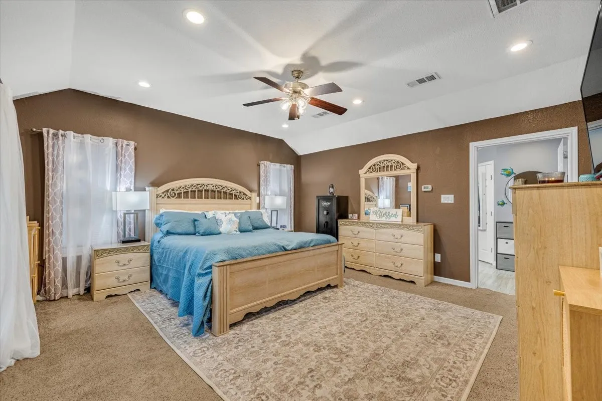 Vaulted ceiling featuring recessed lighting and a central ceiling fan