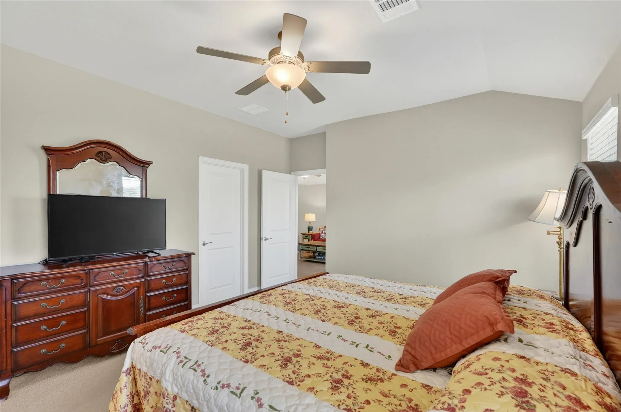 Vaulted ceiling featuring a ceiling fan with integrated lighting