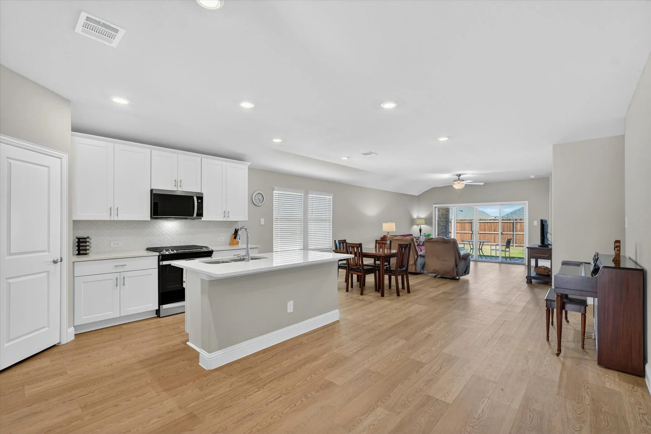 Open-concept interior featuring light wood-finish flooring throughout
