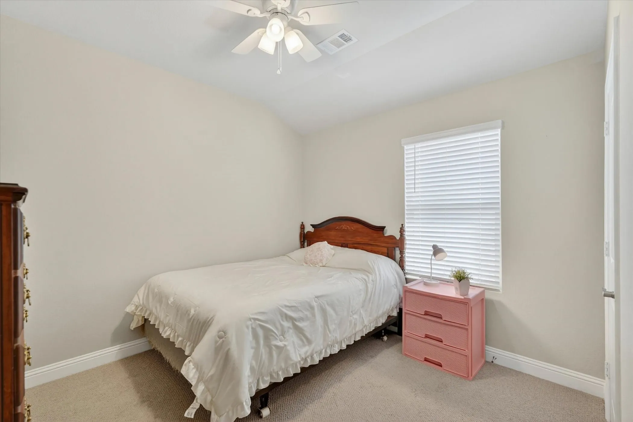 Carpeted interior room featuring light neutral wall tones and white baseboards