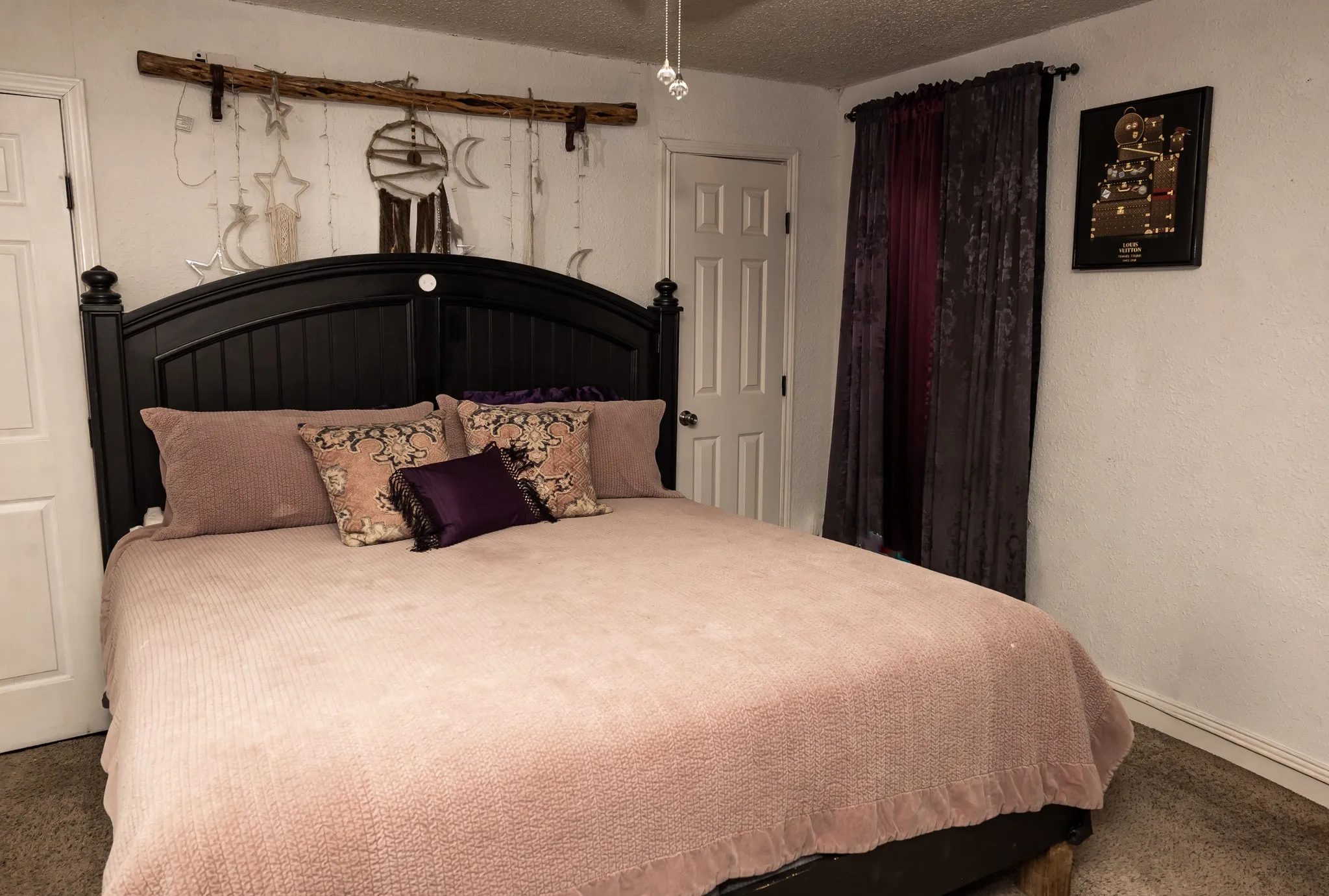 Room featuring neutral wall finishes, multi-panel interior doors, and a ceiling-mounted light fixture