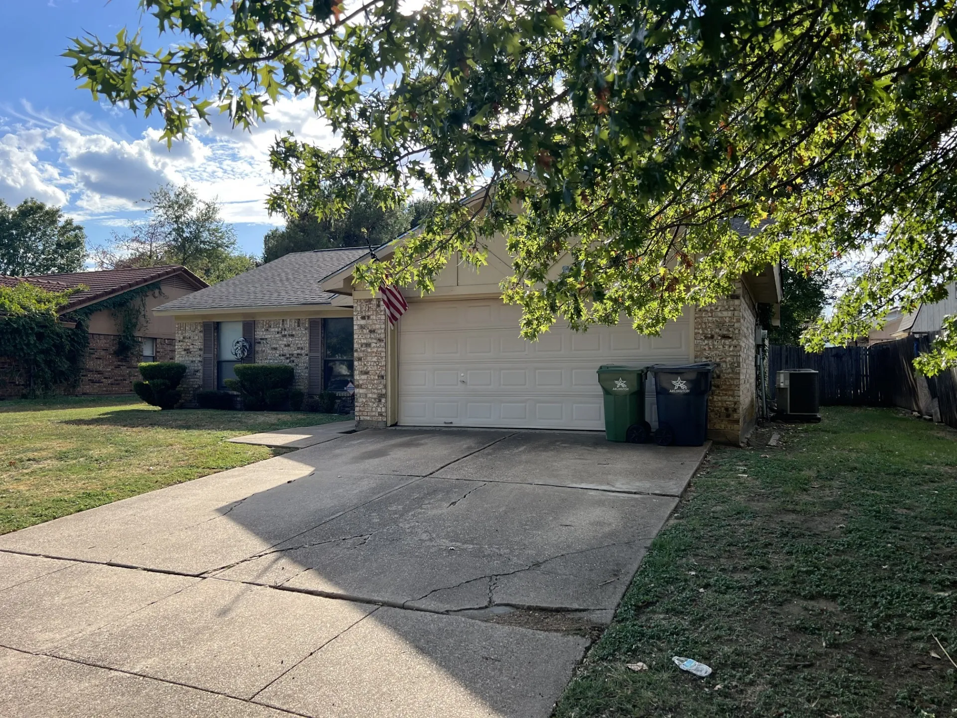 Brick exterior facade with an attached garage and concrete driveway