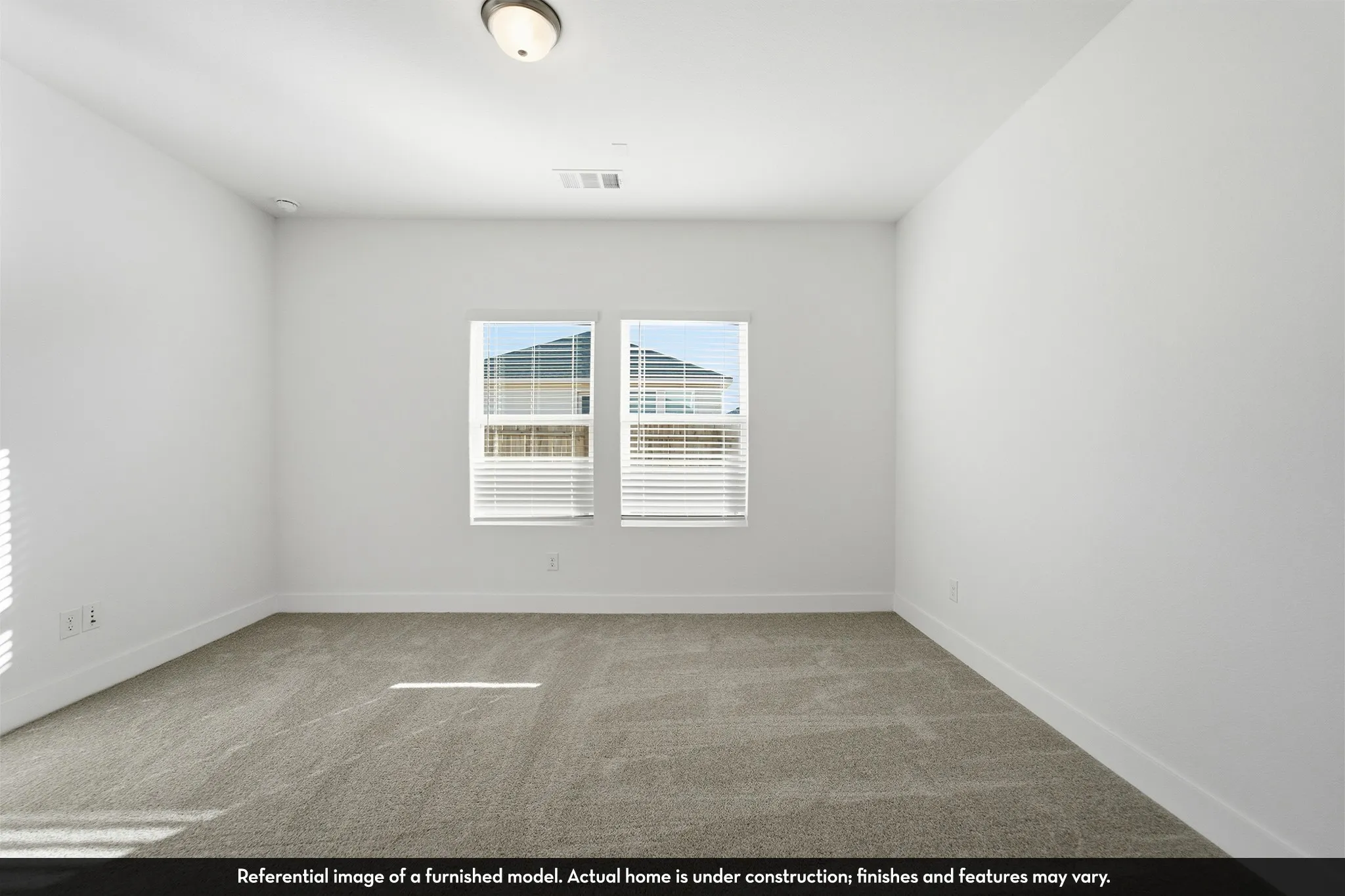 Neutral-toned wall-to-wall carpeting, dual-pane windows, and a flush-mount ceiling fixture