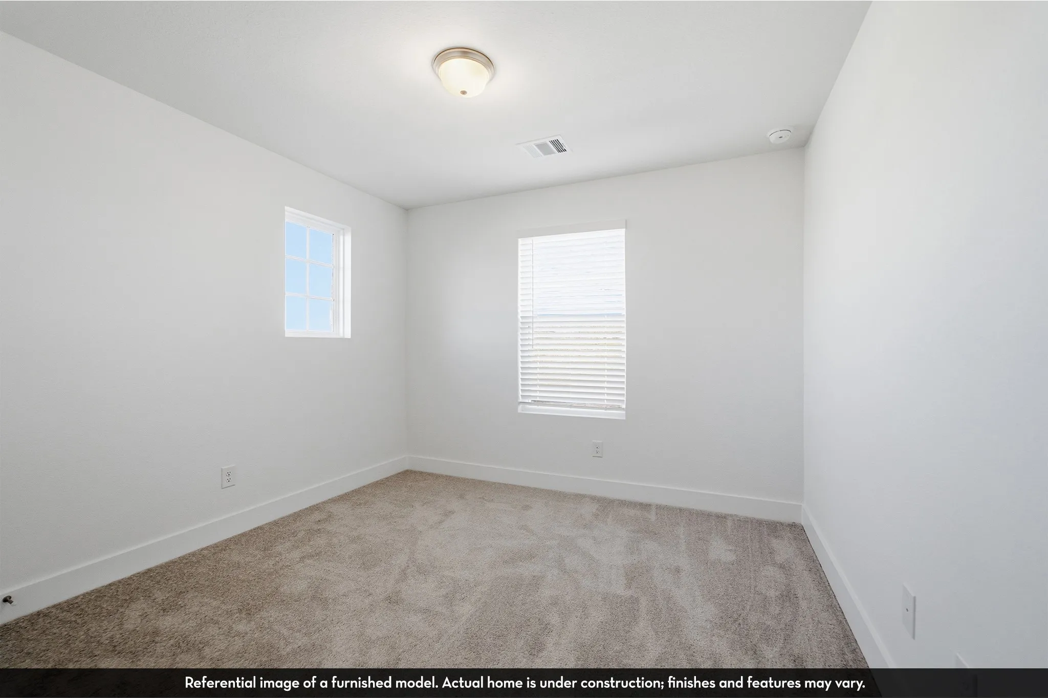 Neutral interior space featuring high-pile wall-to-wall carpeting, two multi-pane windows, and a flush-mount ceiling light fixture