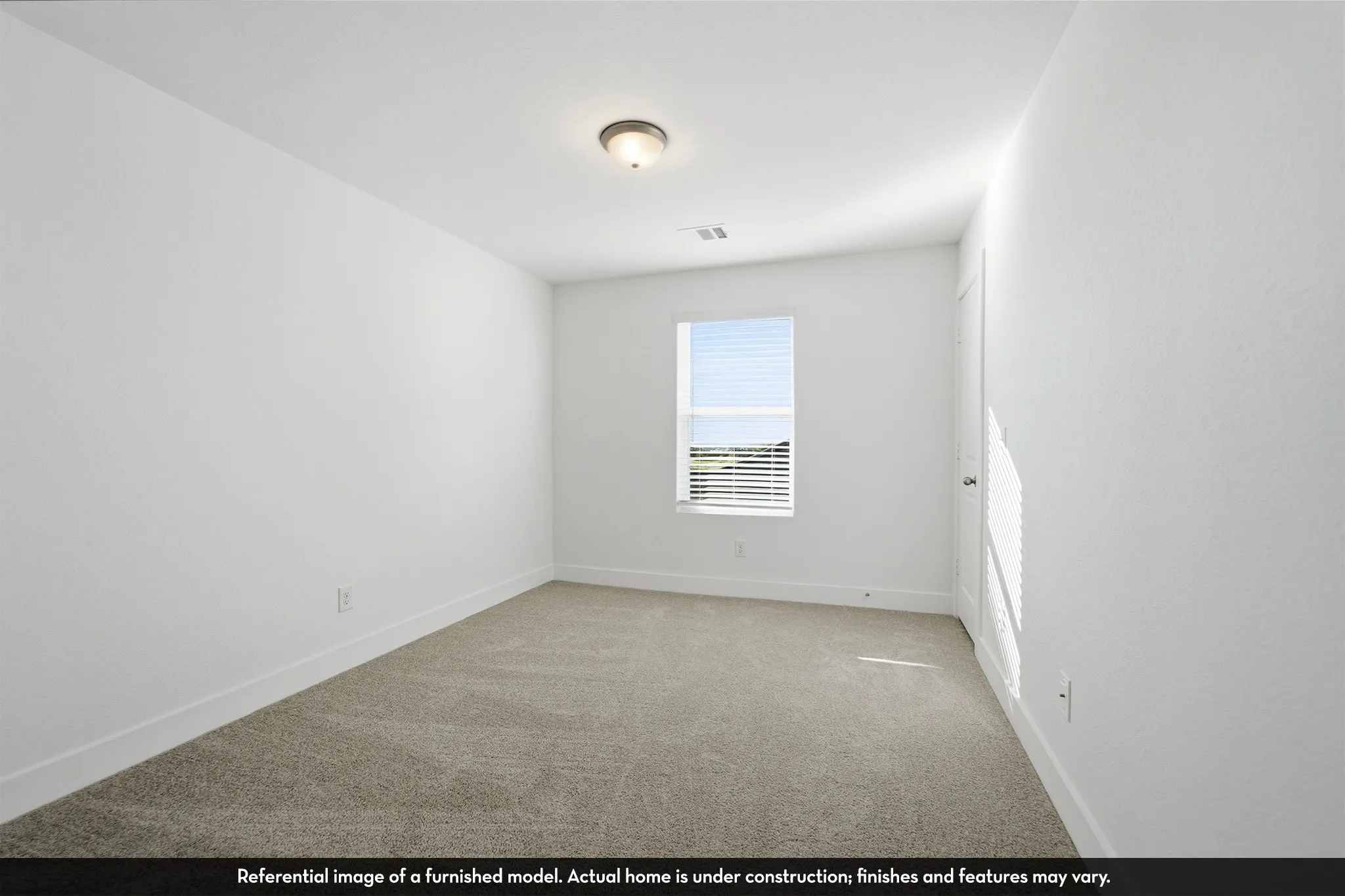 Interior room featuring neutral wall-to-wall carpeting, crisp white walls, a single window with blinds, and a flush-mount ceiling light fixture