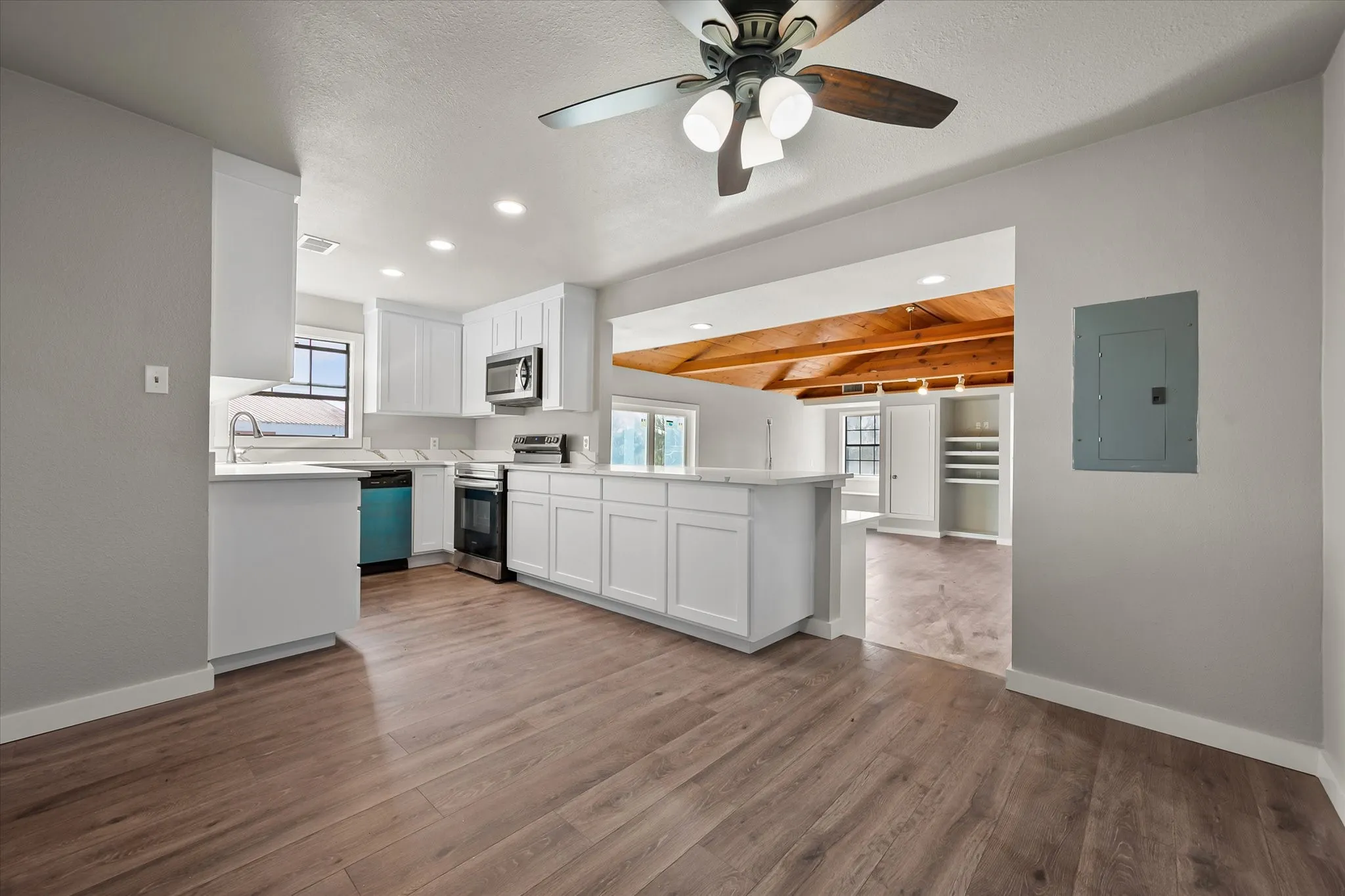 Kitchen featuring white cabinetry, wood-finish flooring, recessed lighting, and a ceiling fan