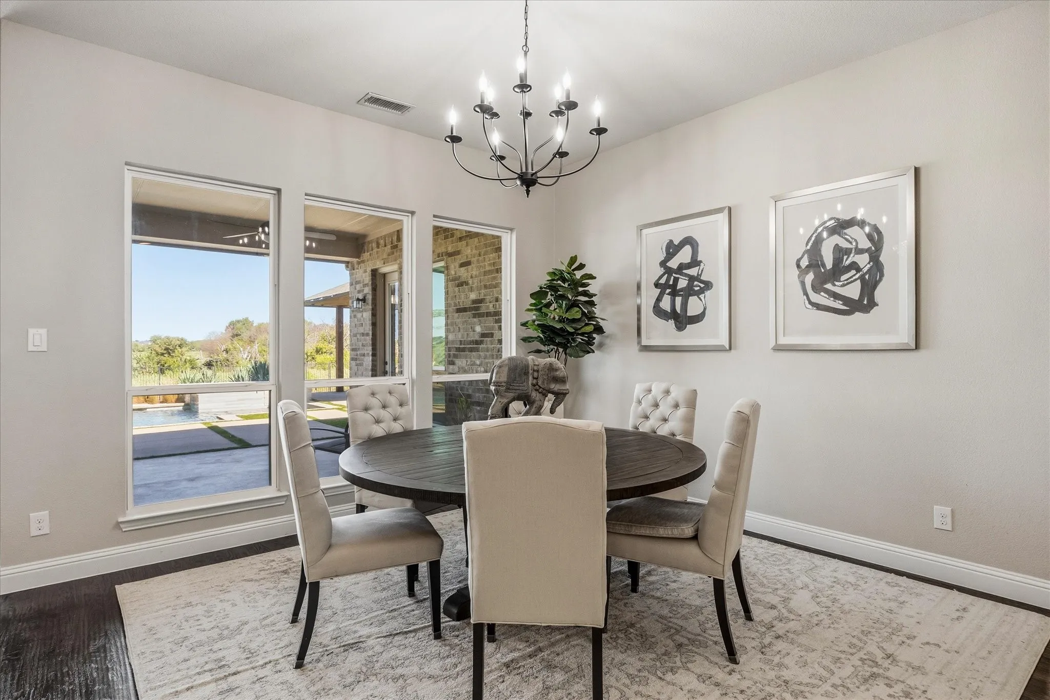 Multiple large windows, dark wood-finish flooring