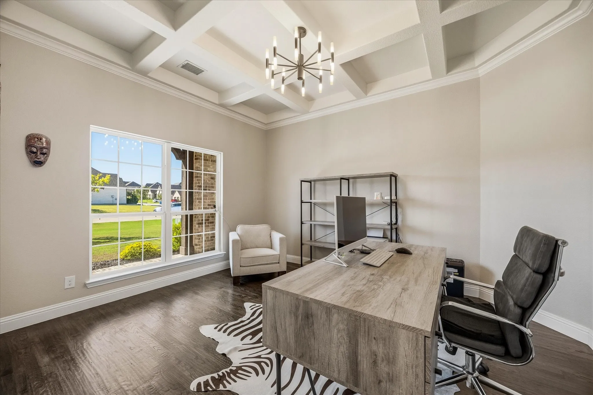 Coffered ceiling, contemporary chandelier, wood-finish flooring, white trim, and a large window