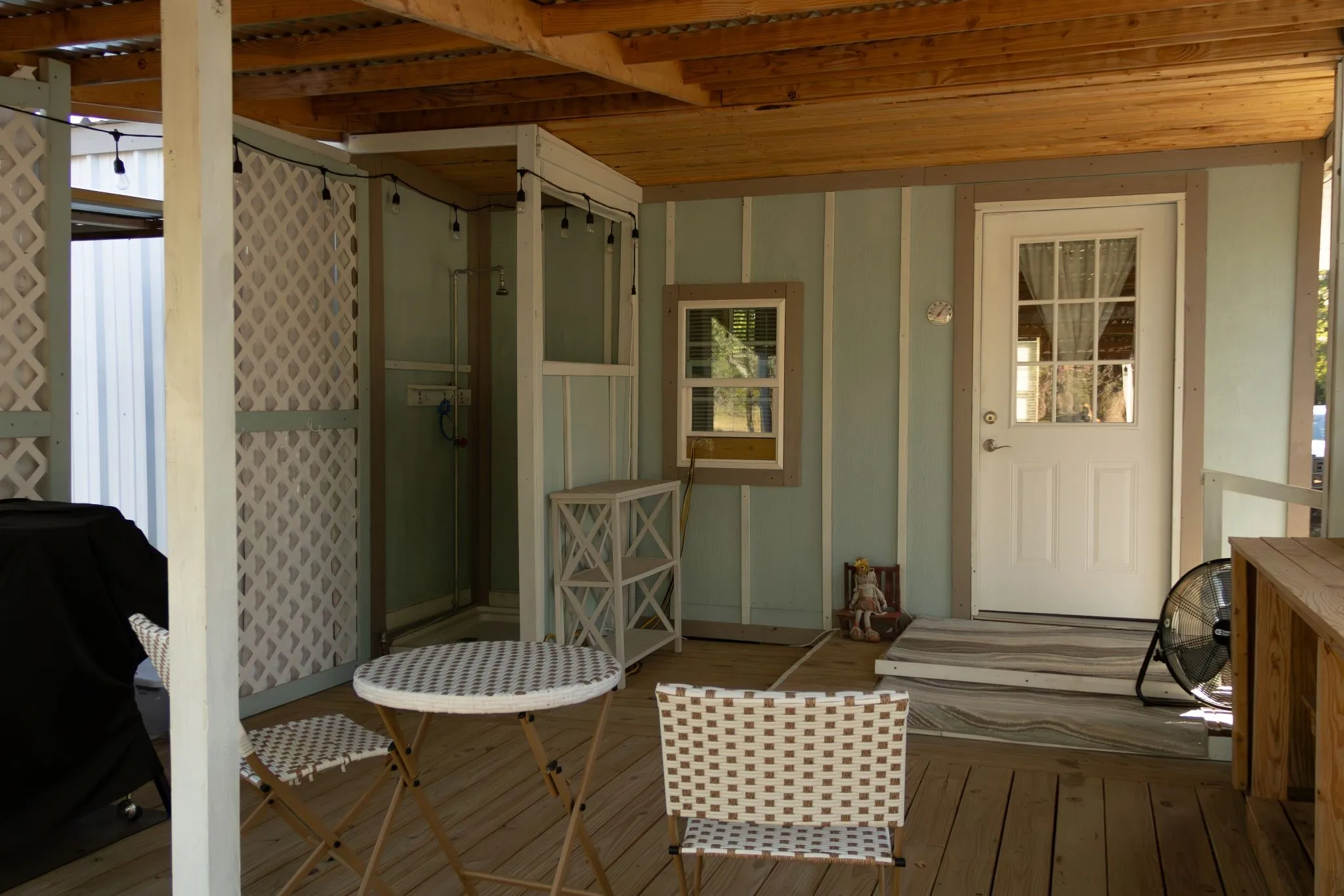 Deck with back door and outdoor shower.