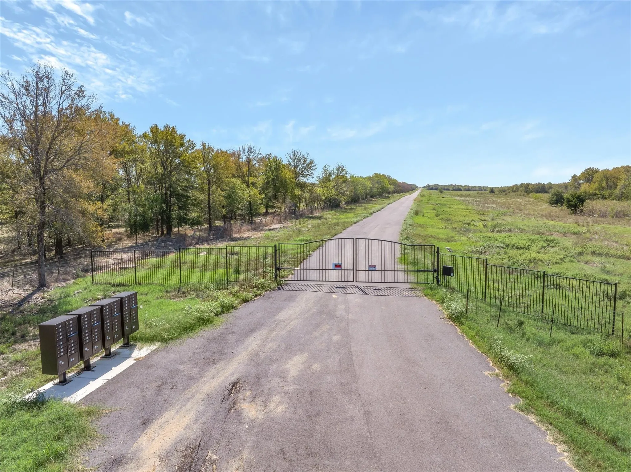 Gated entry with a paved private road