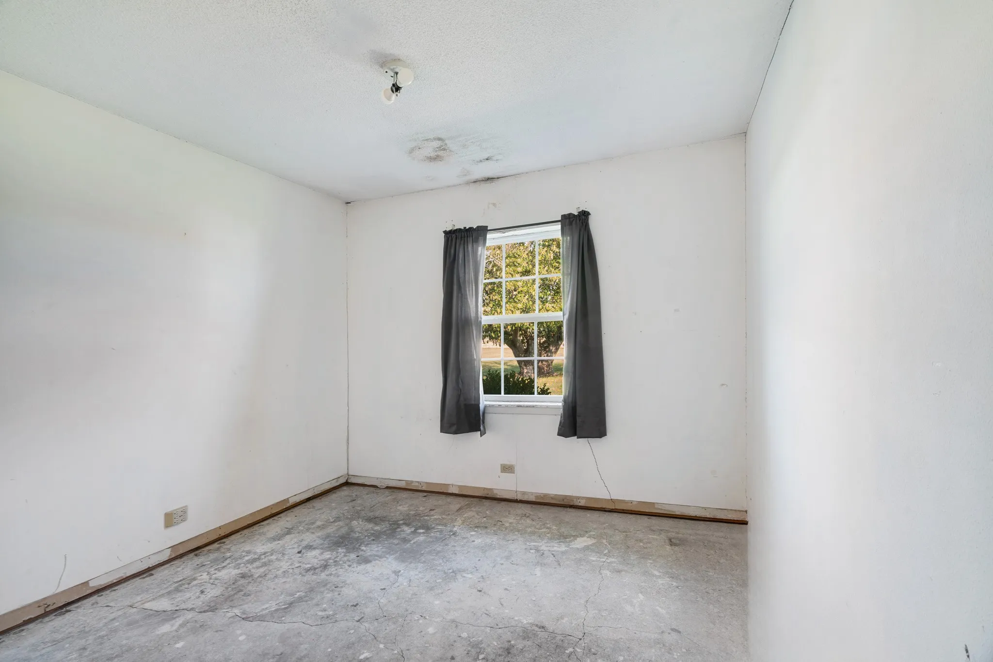 Spare room featuring baseboards