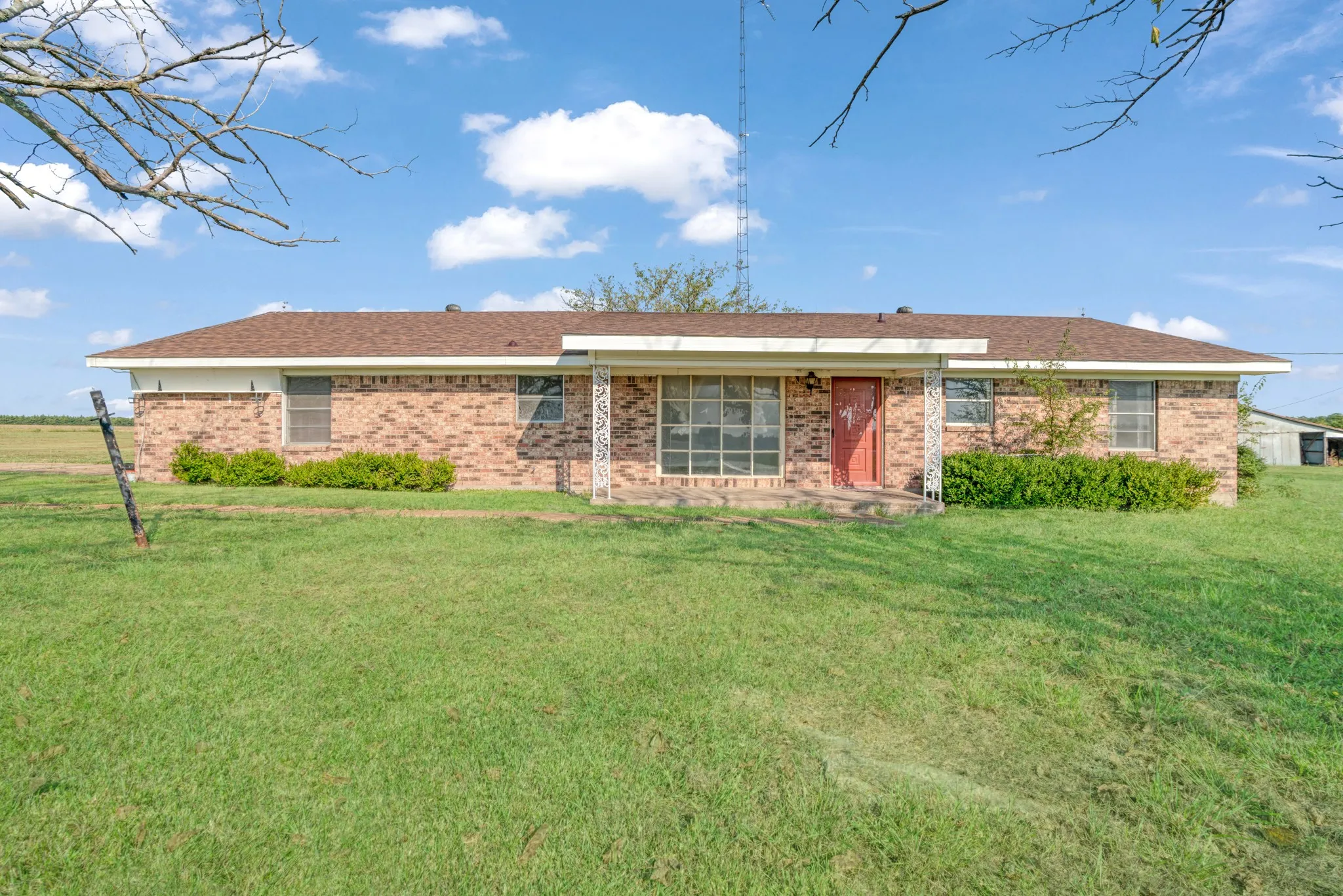 Ranch-style home with brick siding and a front lawn