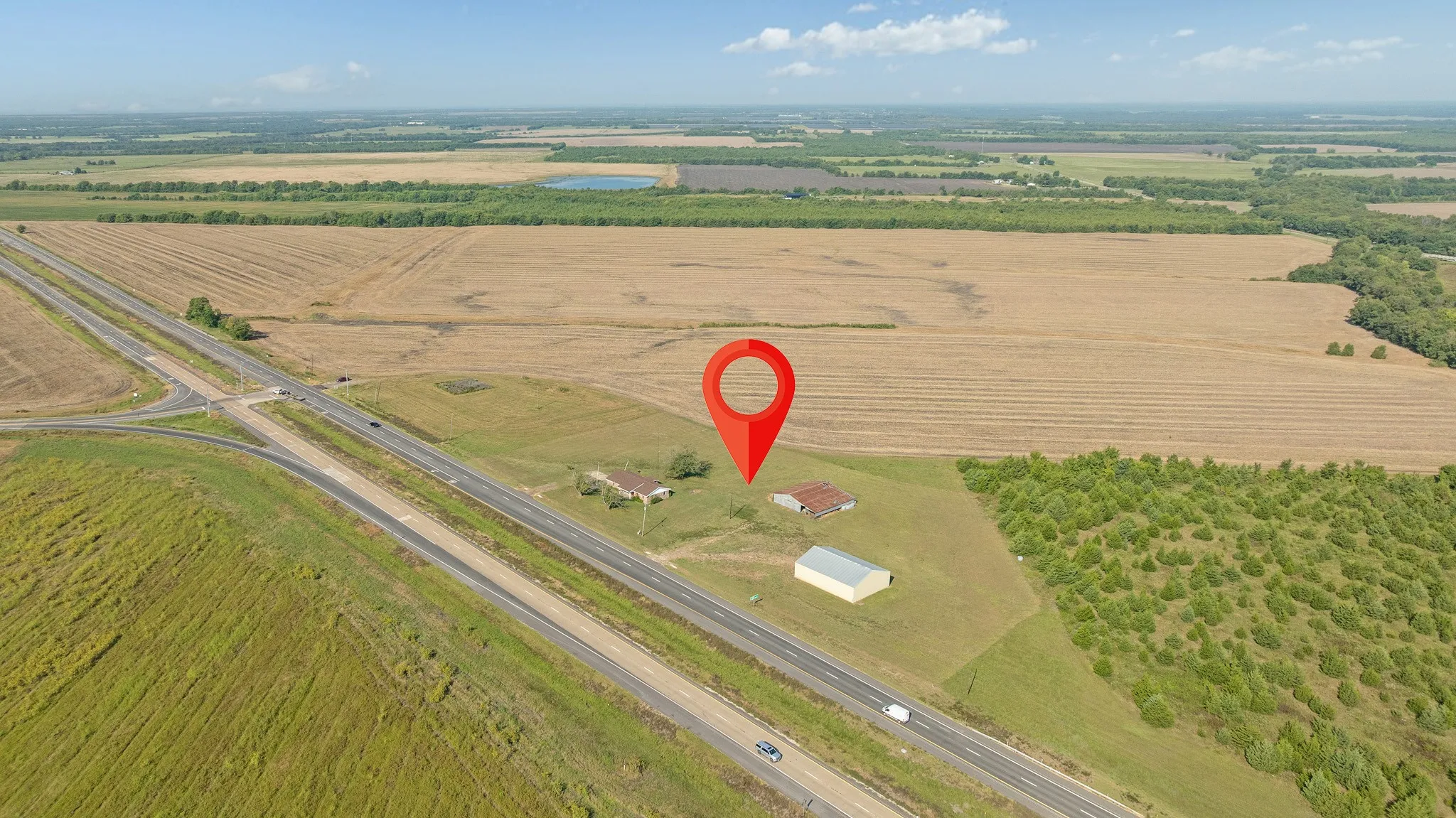 Aerial overview of property's location with large plots for crops and rural landscape