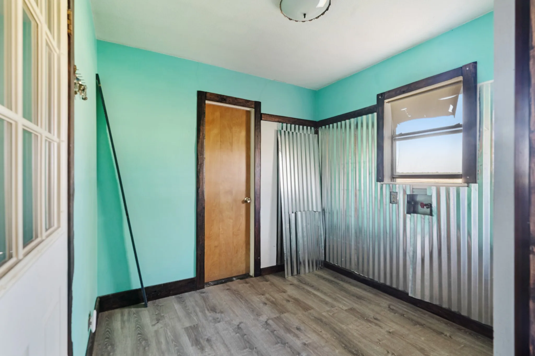 Unfurnished bedroom featuring wood finished floors and a closet