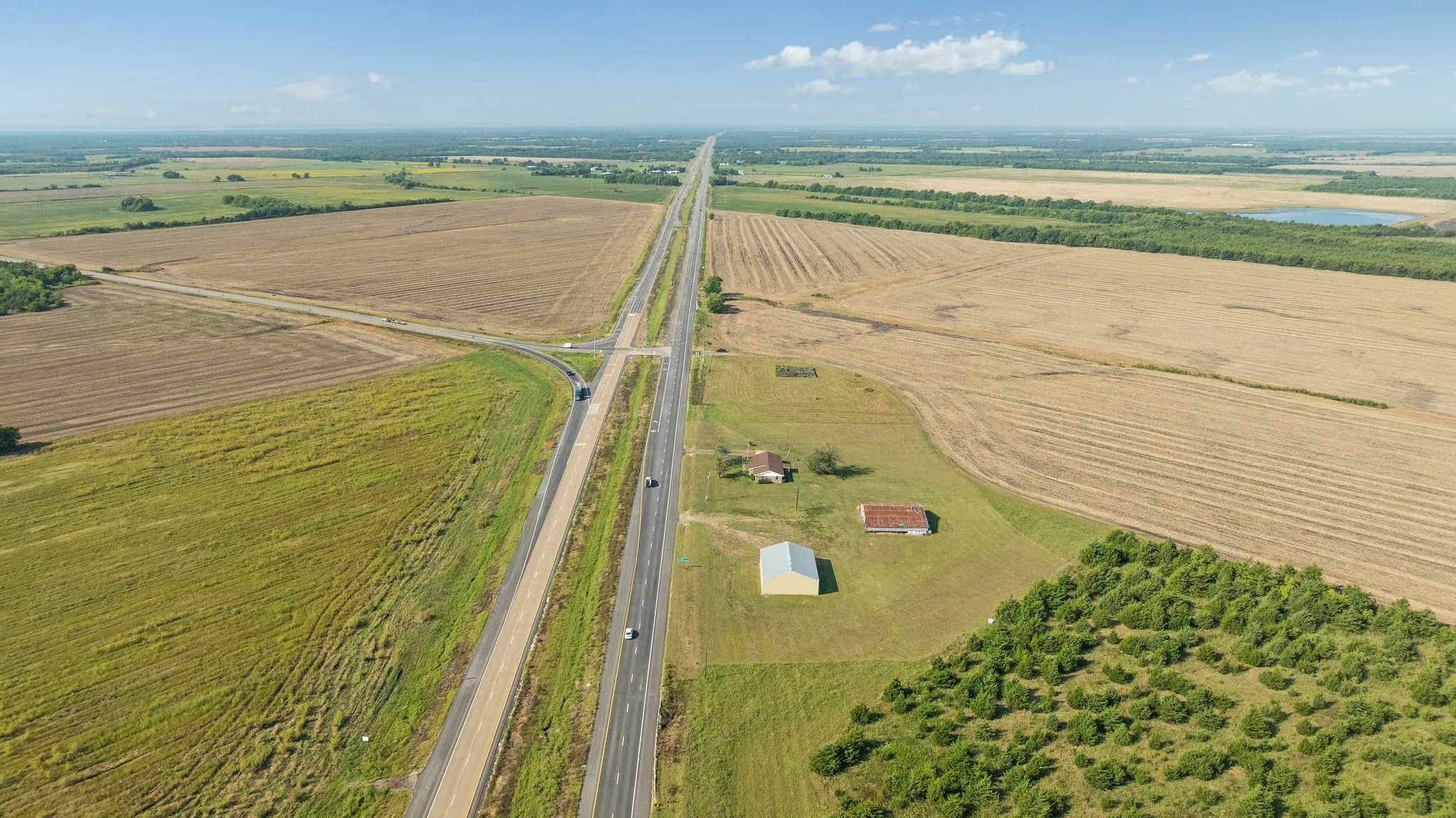 Aerial view of property and surrounding area featuring extensive farmland and rural landscape