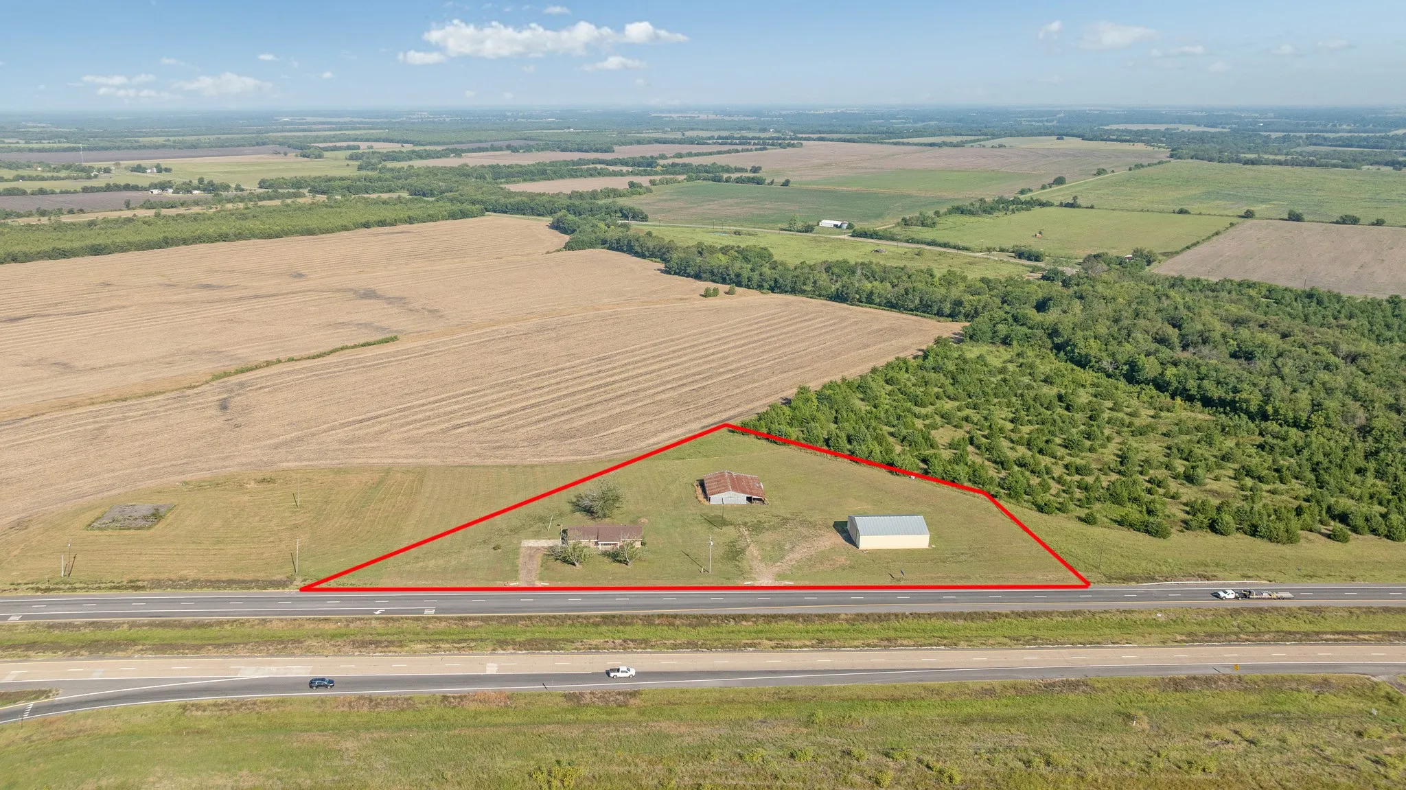 Overview of rural landscape featuring rows of crops and property parcel outlined