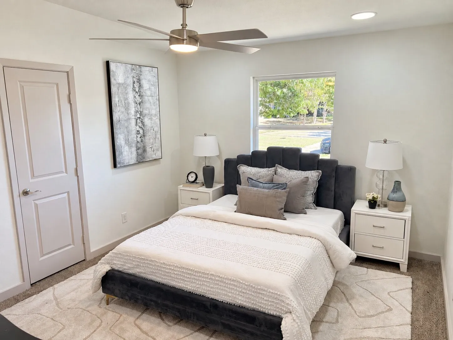 Neutral interior featuring carpeted flooring, a ceiling fan with integrated lighting, recessed lighting, and a multi-pane window