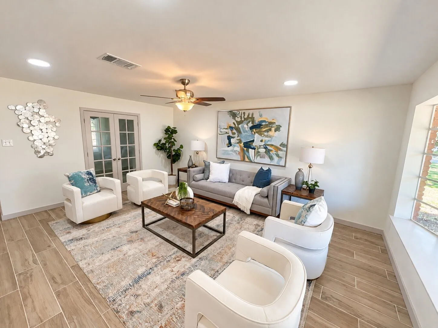 Living space featuring wood-finish flooring, recessed lighting, a multi-light ceiling fan, and French doors