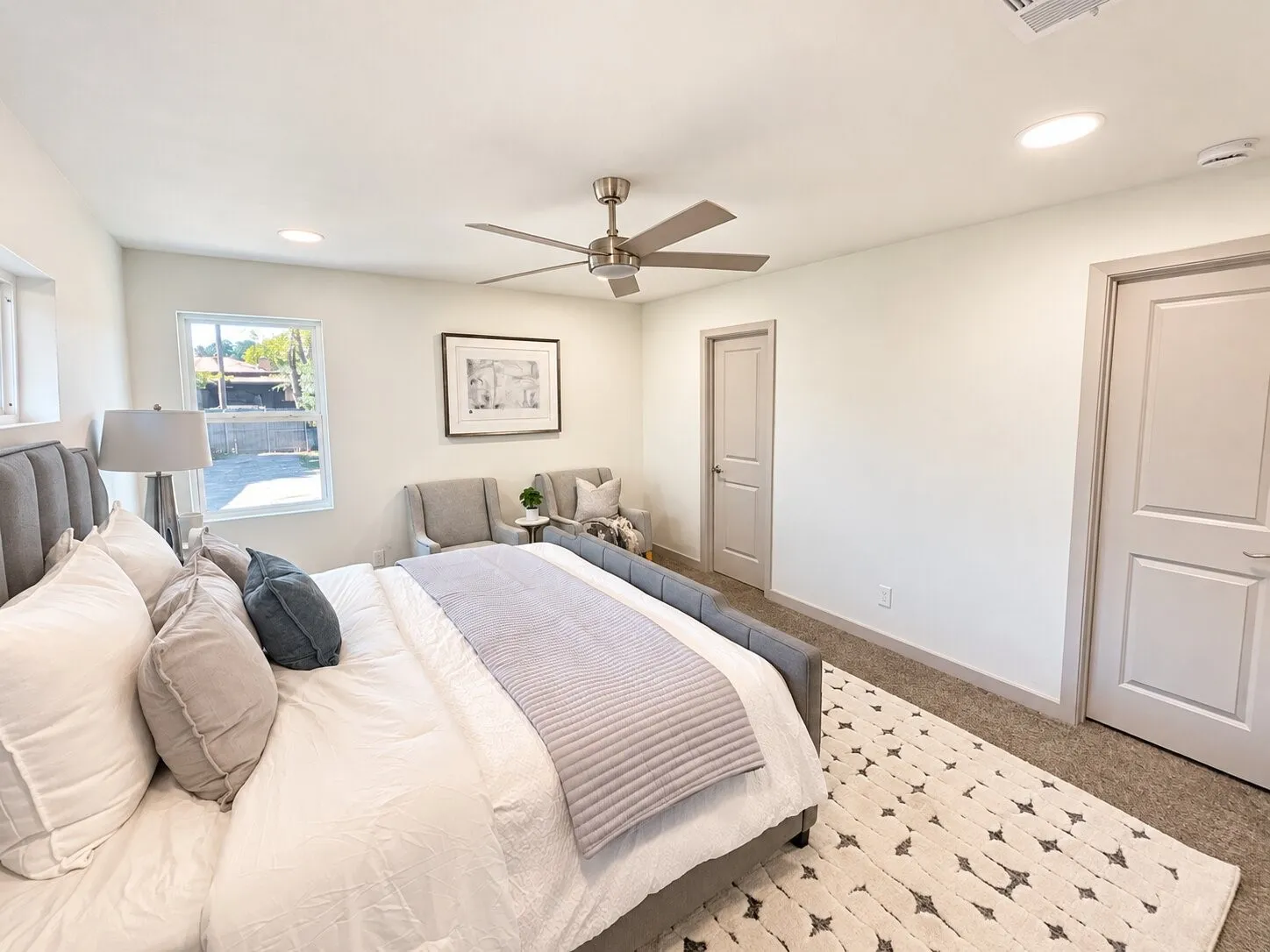 Neutral-toned bedroom featuring recessed lighting, a brushed-nickel ceiling fan, carpeted flooring, and two-panel interior doors
