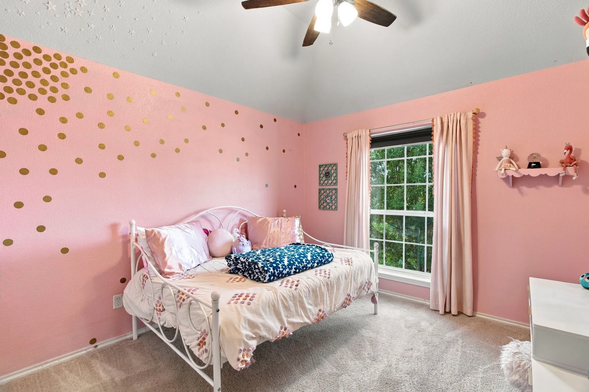 Bedroom featuring a high vaulted ceiling, neutral wall-to-wall carpeting, and a multi-blade ceiling fan with integrated light fixture