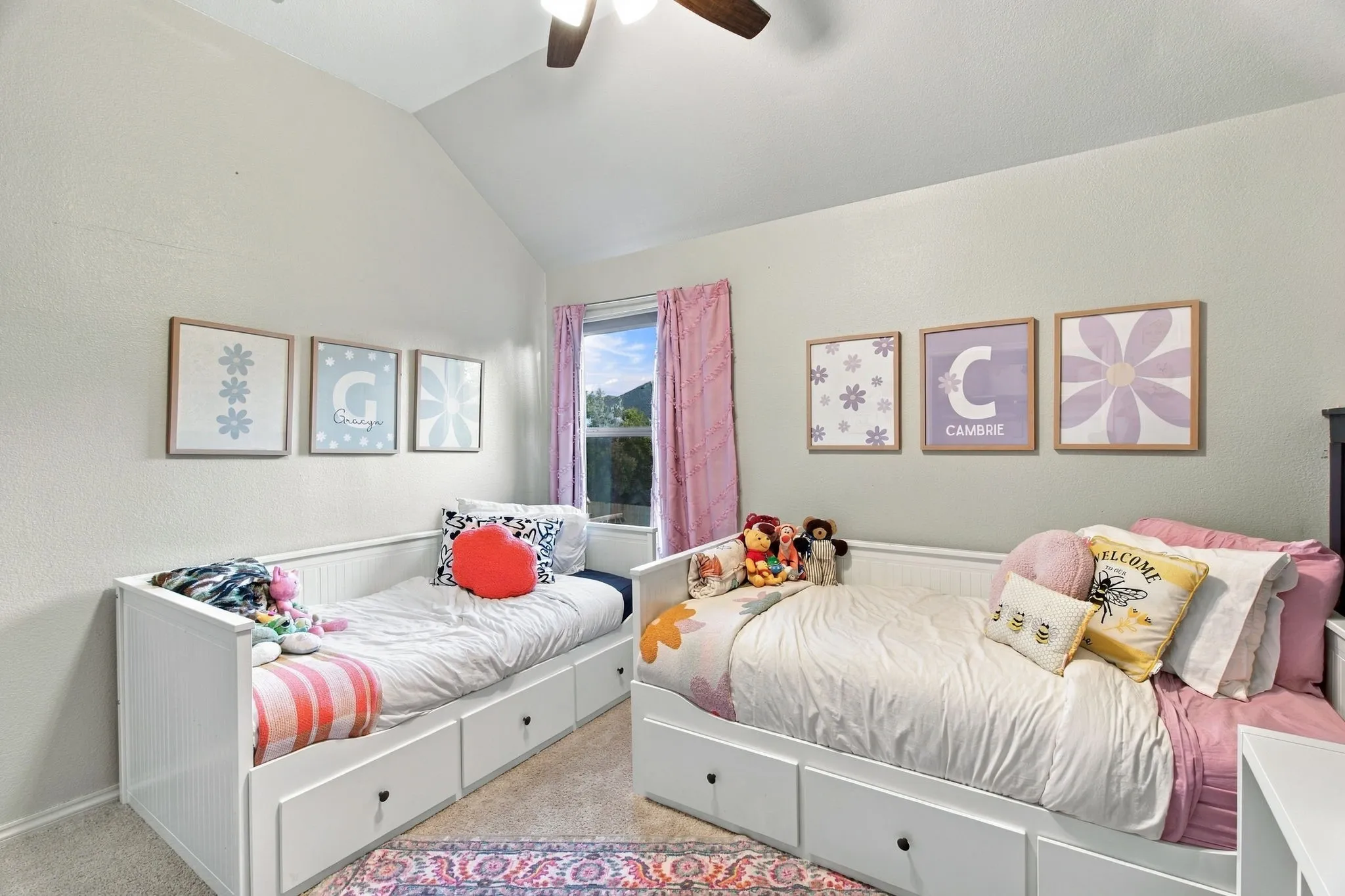 Vaulted ceilings, neutral wall tones, window with natural lighting, and overhead ceiling fan