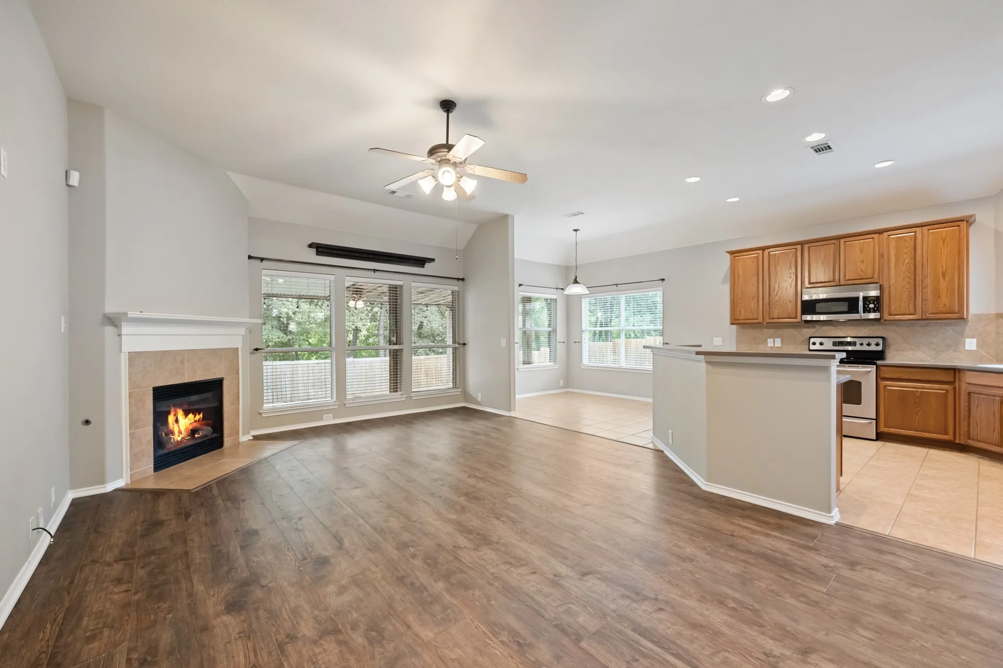 Large living room with fireplace open to kitchen