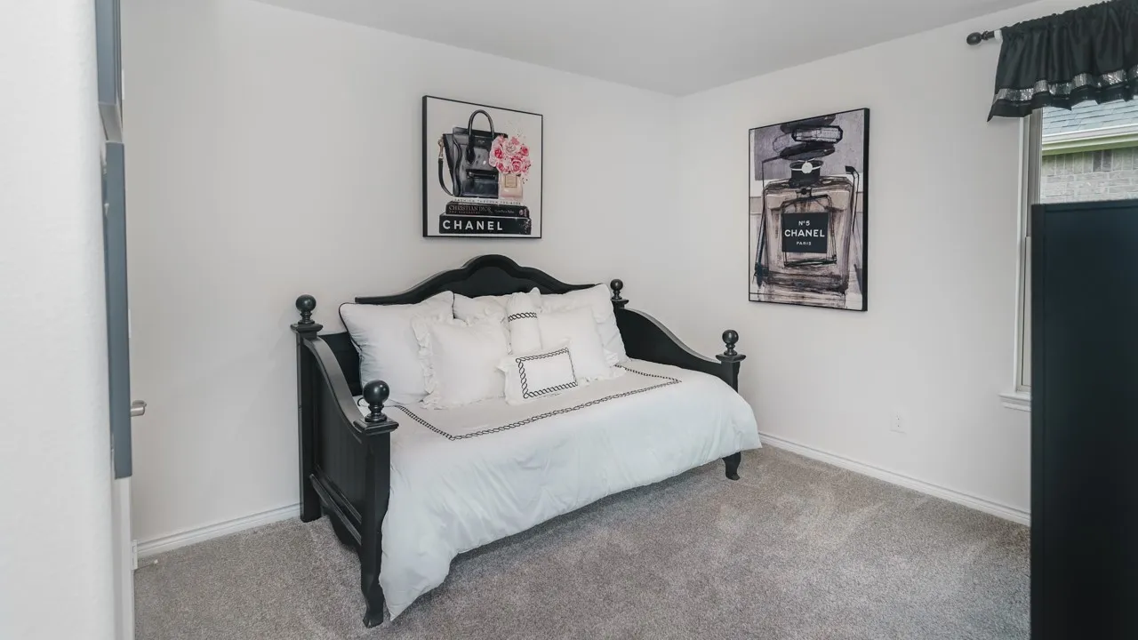 Carpeted room with a window featuring white trim