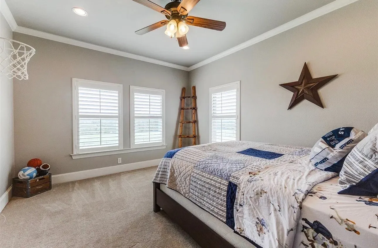 Neutral-toned interior featuring plantation shutters, recessed lighting, crown molding, and a ceiling fan with integrated light fixture
