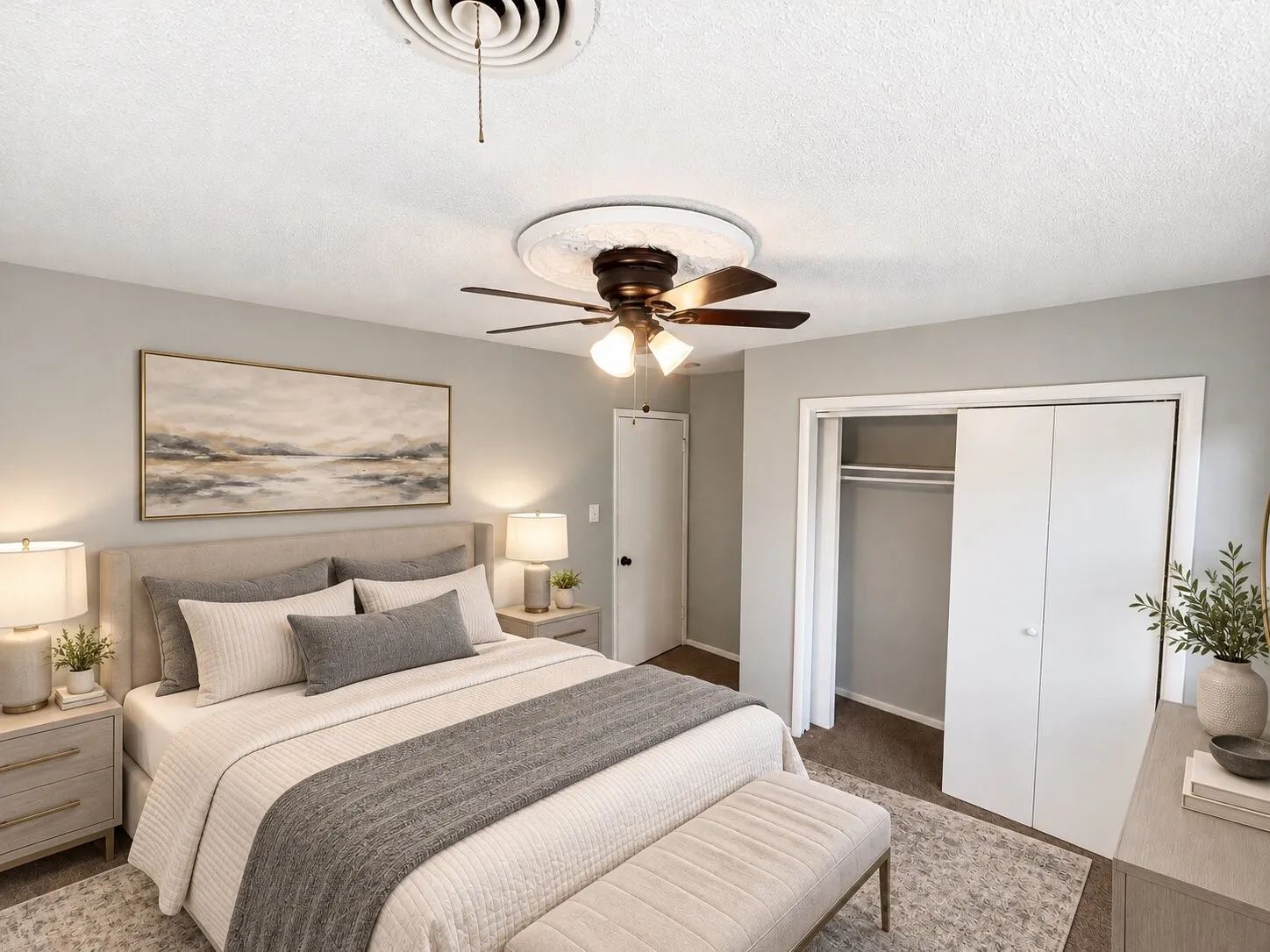 Ceiling fan with ornate decorative medallion, neutral wall paint, and double-door reach-in closet