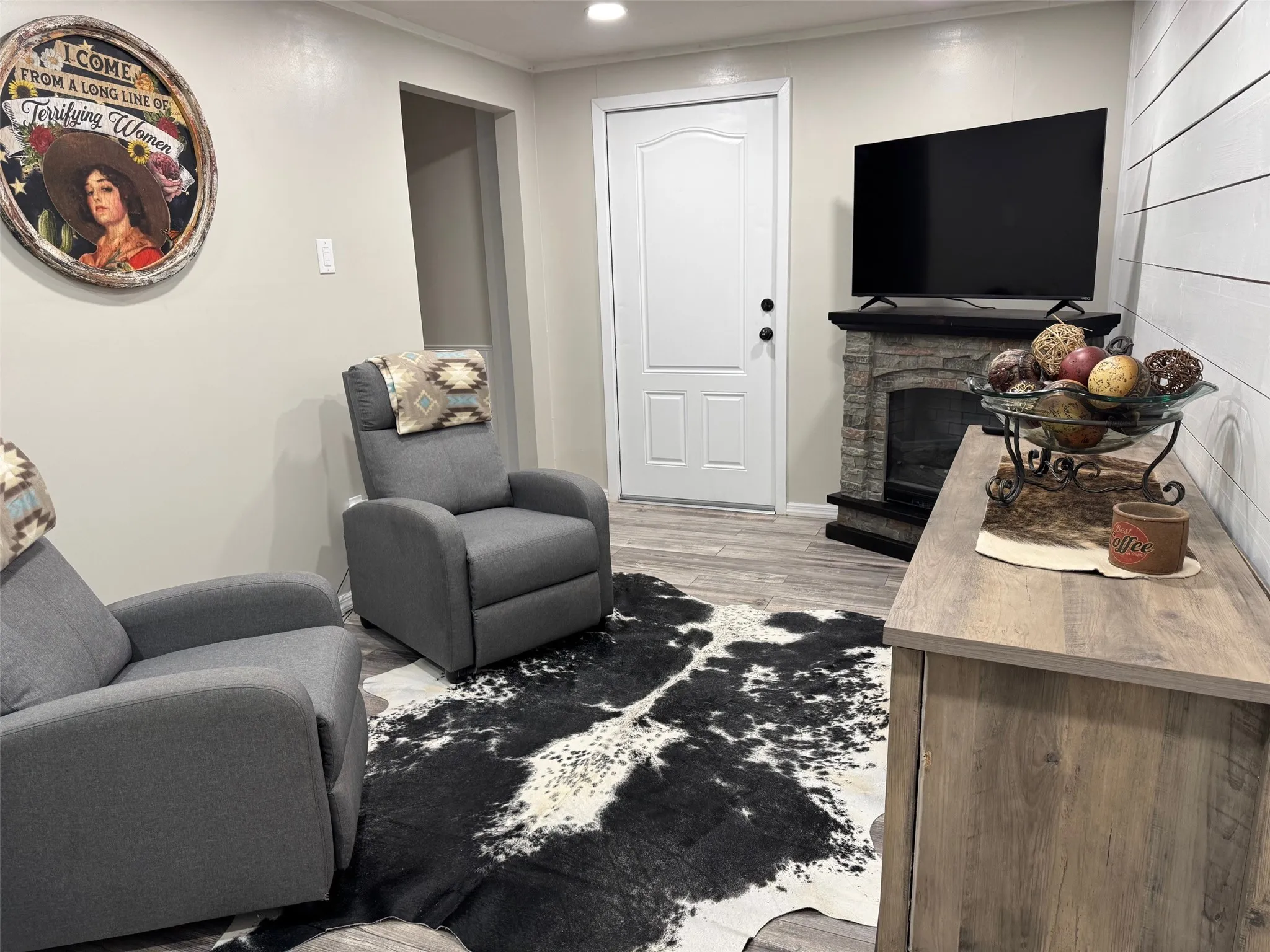 Living area featuring a fireplace, recessed lighting, and light wood-style floors