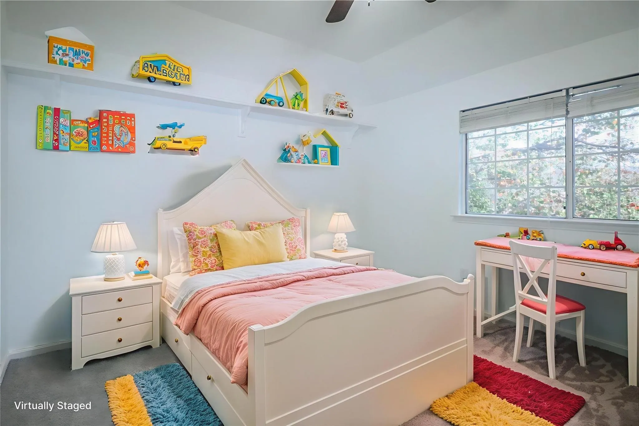 Bedroom featuring neutral wall-to-wall carpeting, vaulted ceilings with an integrated overhead fan, and a grid-style window