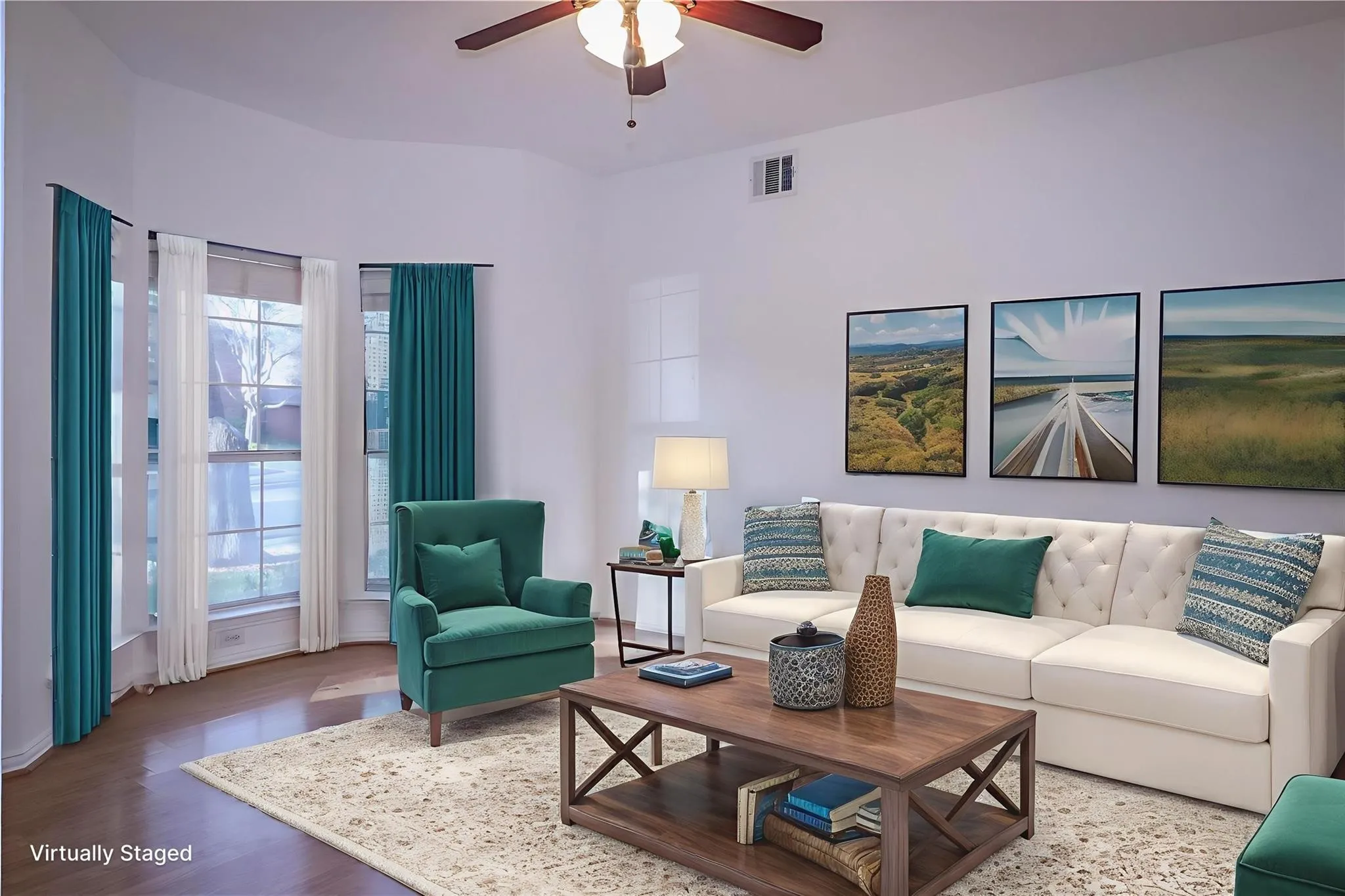 Living area featuring a bay window, wood-finish flooring, and a ceiling fan with integrated lighting