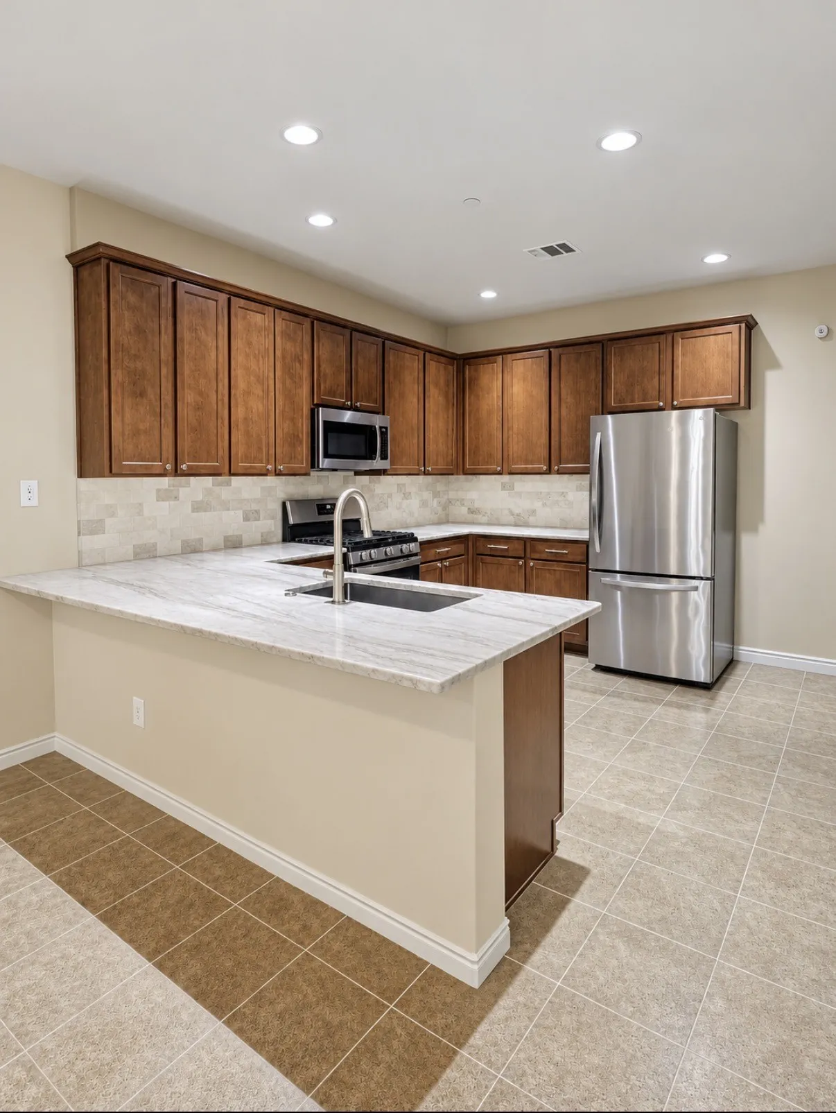 Kitchen featuring wood cabinetry, stone-surface countertops, tile backsplash, stainless steel appliances, and ceramic tile flooring