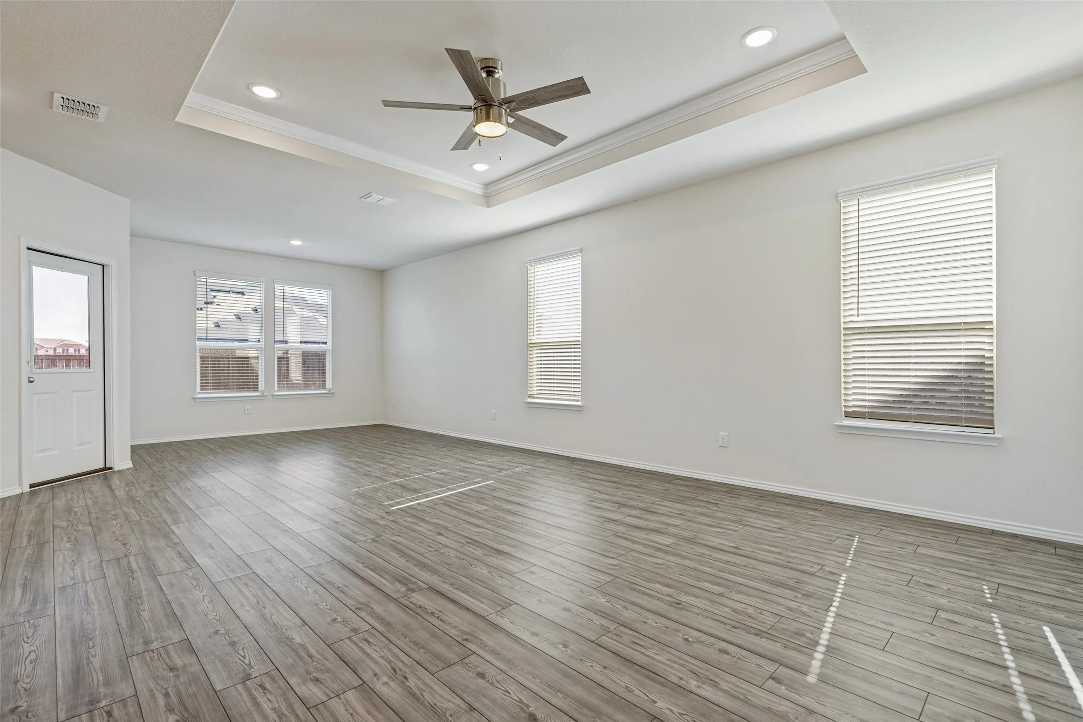 Living and dining areas have an abundance of natural light and a decorative tray ceiling for added elegance