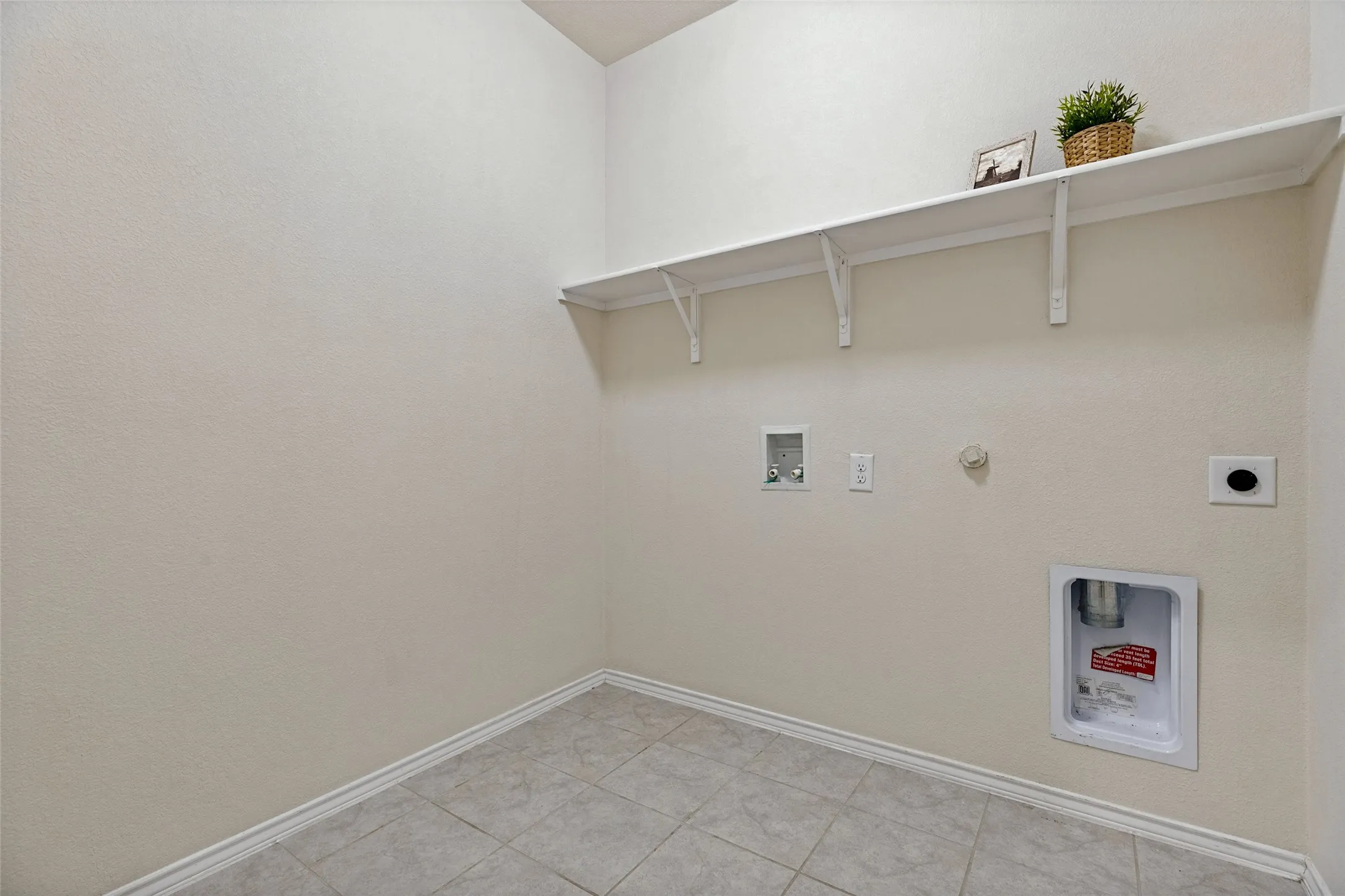 Oversized laundry room with plenty of space for freezer or storage