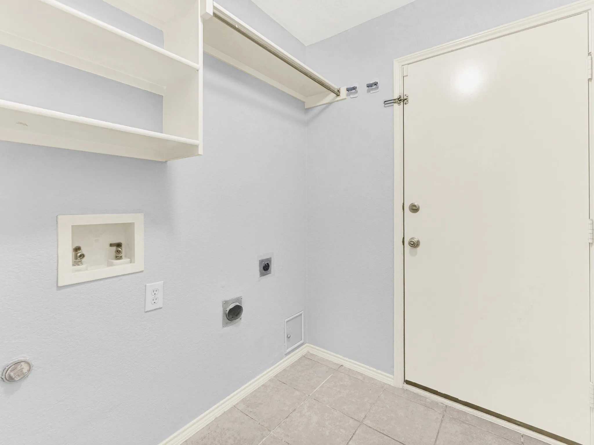 Utility room has extra shelving rod to hang clothes
