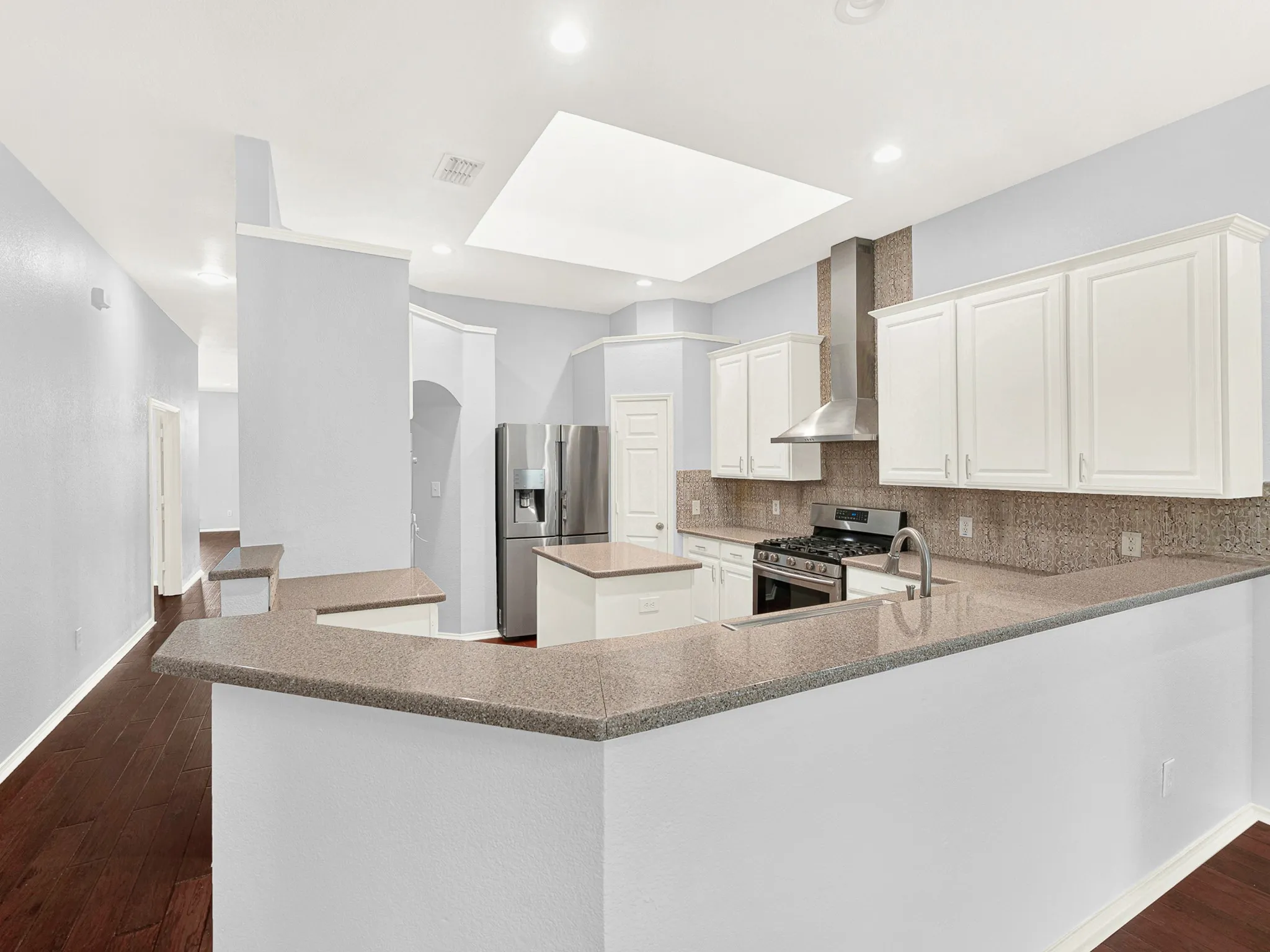 Natural light flows into the kitchen from the huge skylight above