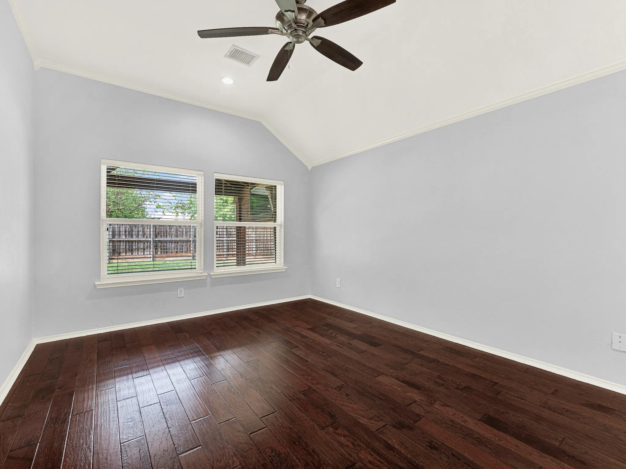 Primary bedroom overlooks backyard