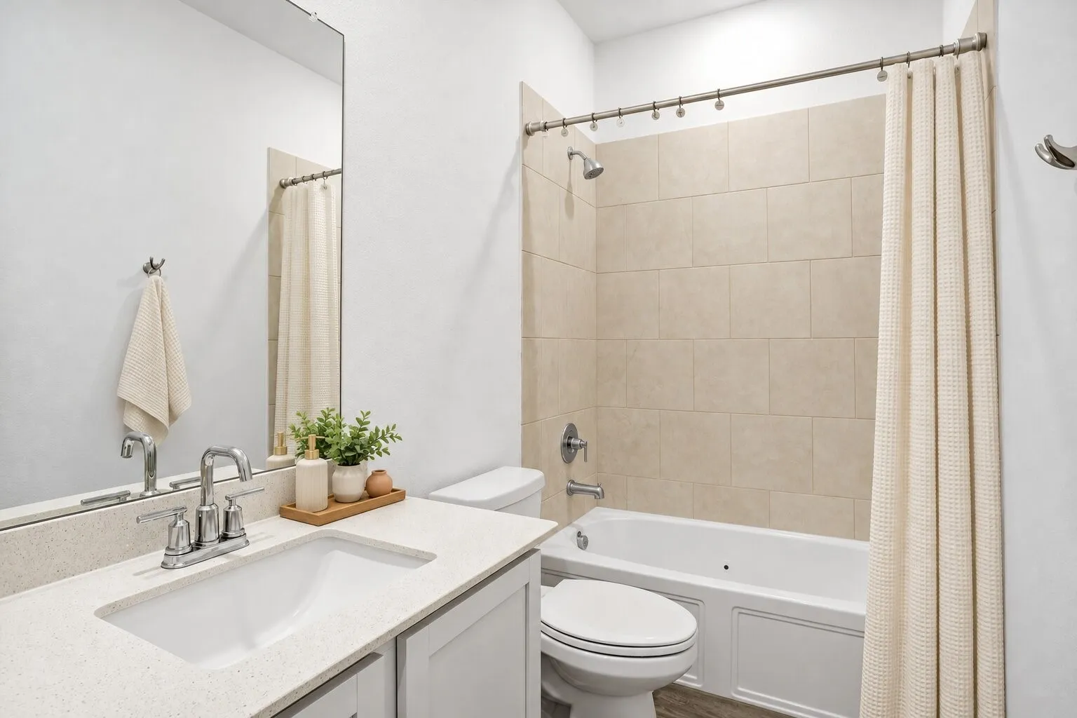 Full bathroom between two of the secondary bedrooms; Photo has been digitally enhanced and/or virtually staged using AI.