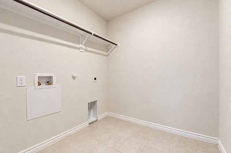 Ceramic tile flooring, built-in storage rack, electrical outlets, and plumbing connections
