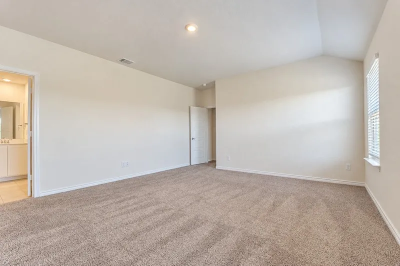 Vaulted ceiling, recessed lighting, neutral tone carpeting, window with blinds, and white interior doors