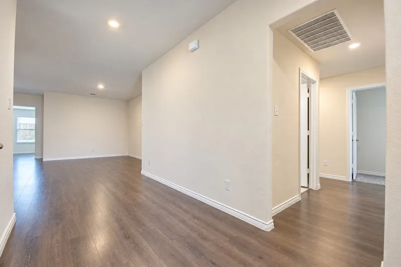 Wood-finish flooring throughout, recessed lighting, and crisp white trim