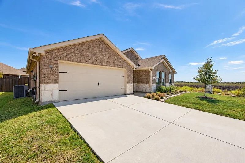 Brick and stone veneer exterior with a two-car garage