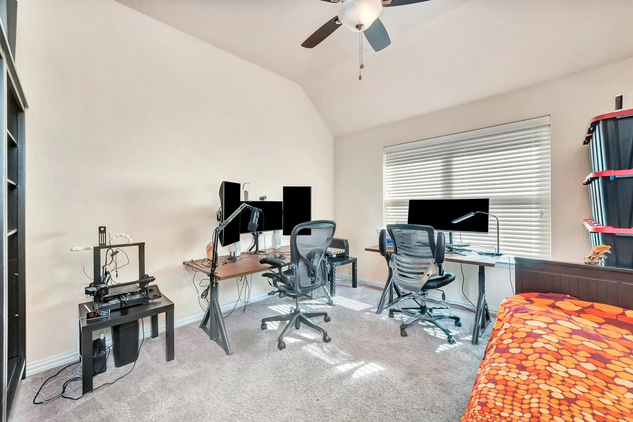 Vaulted ceilings, neutral carpeting, and a ceiling fan with integrated lighting