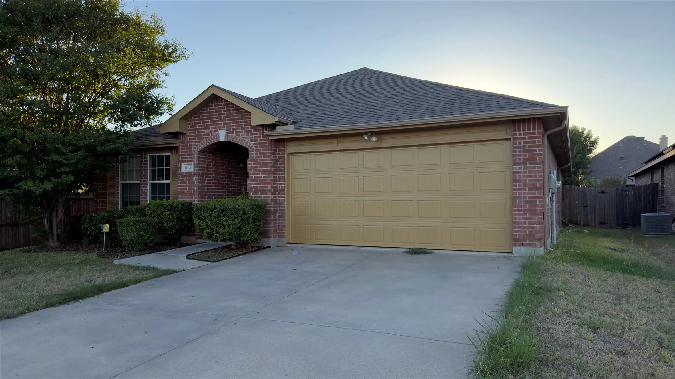 Brick exterior featuring a gabled roofline, recessed entryway, and a two-car garage