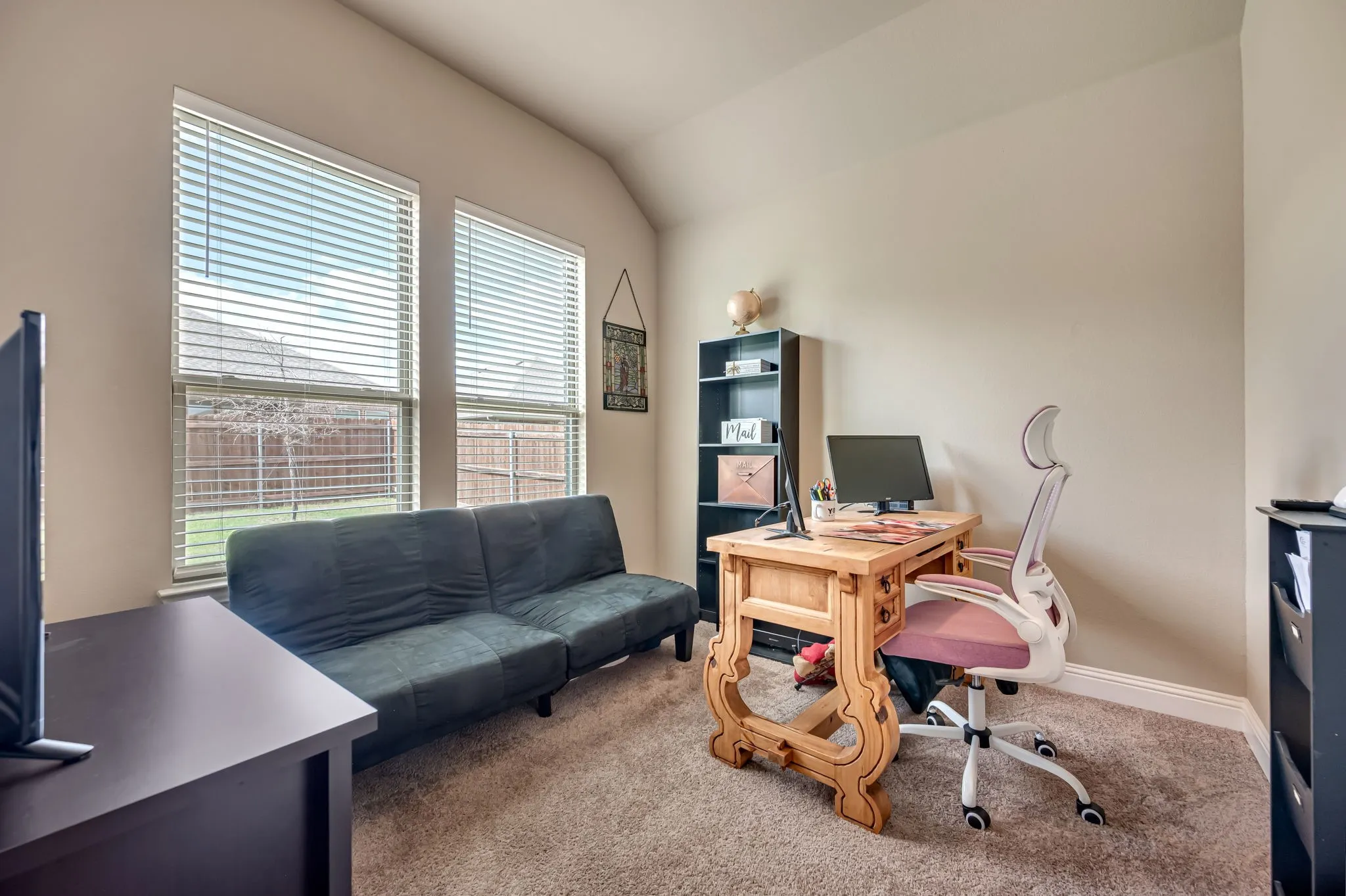 Room featuring neutral wall tones, plush wall-to-wall carpeting, and a vaulted ceiling, illuminated by dual windows with installed horizontal blinds