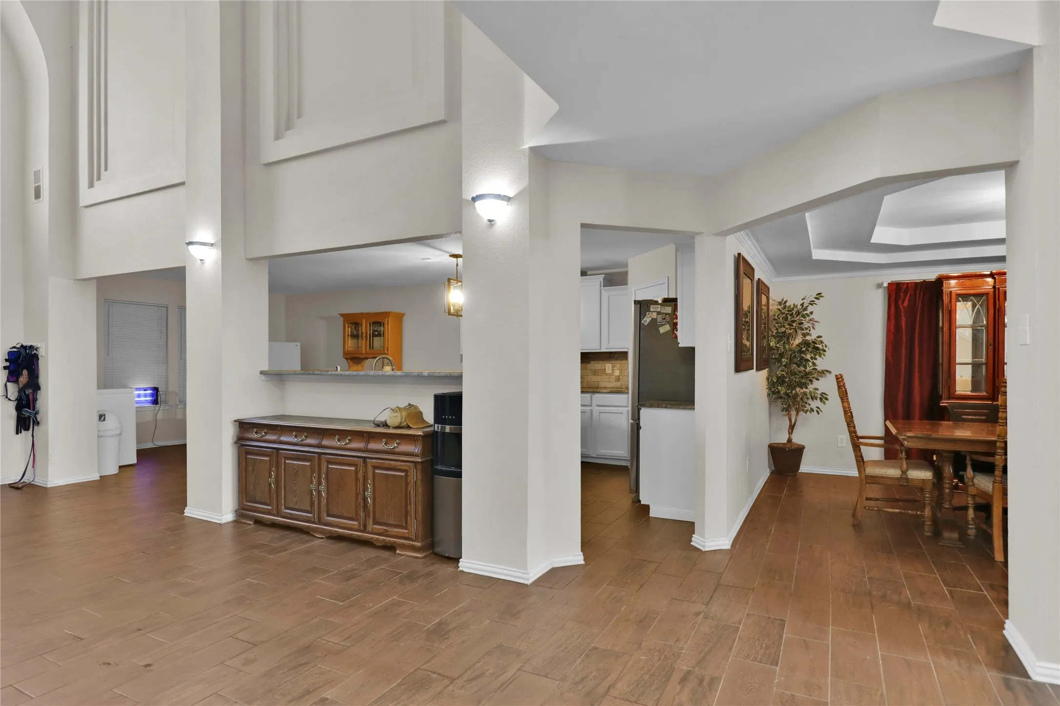 Formal dining to right. Kitchen in center and breakfast area to left. Breakfast bar is where the cabinet is sitting.