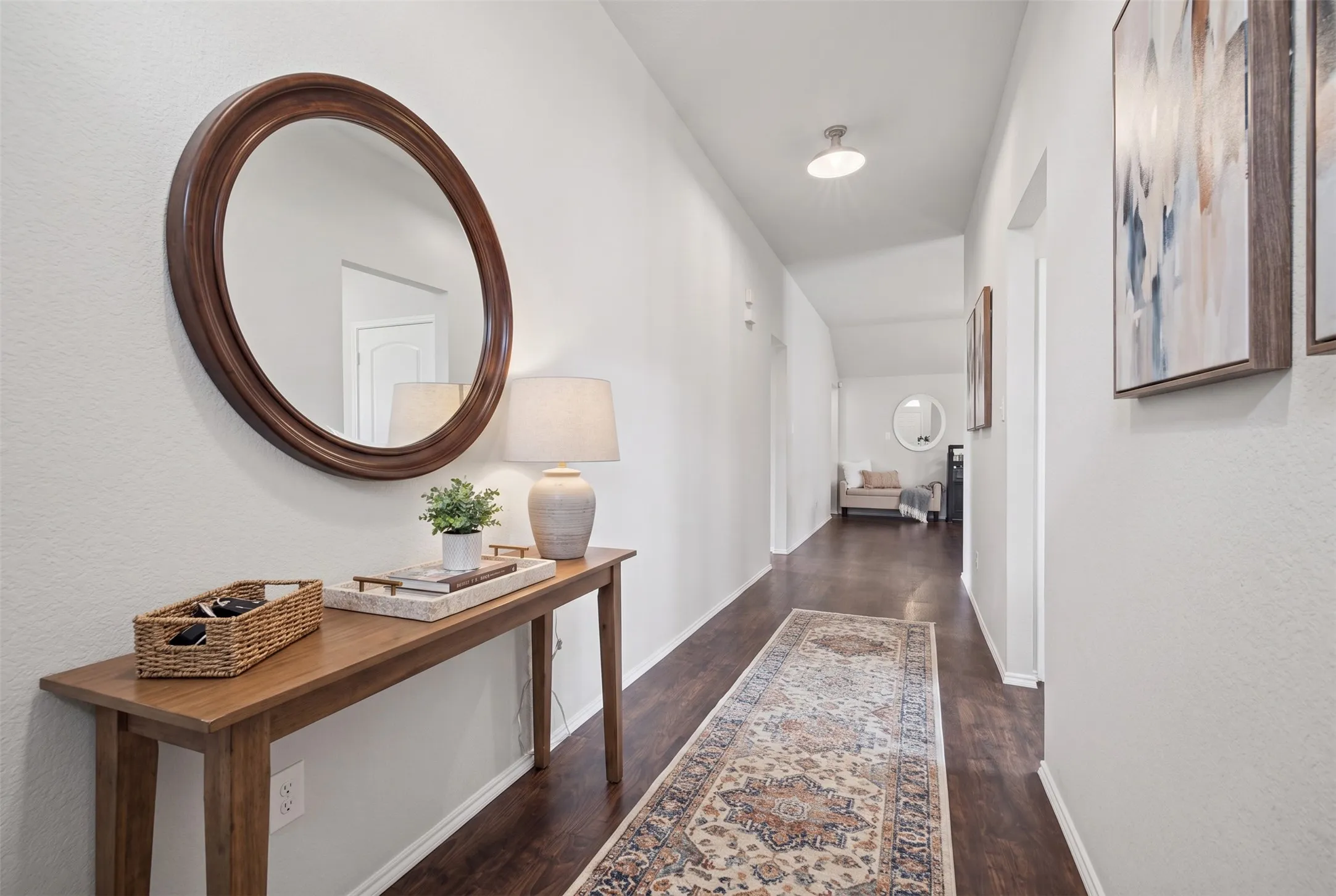 Hallway featuring wood-finish flooring, neutral wall tones, and recessed overhead lighting