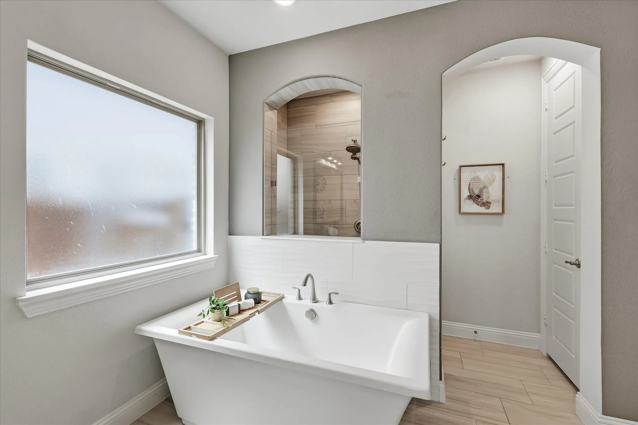 Freestanding white soaking tub and walk in shower. A true spa!
