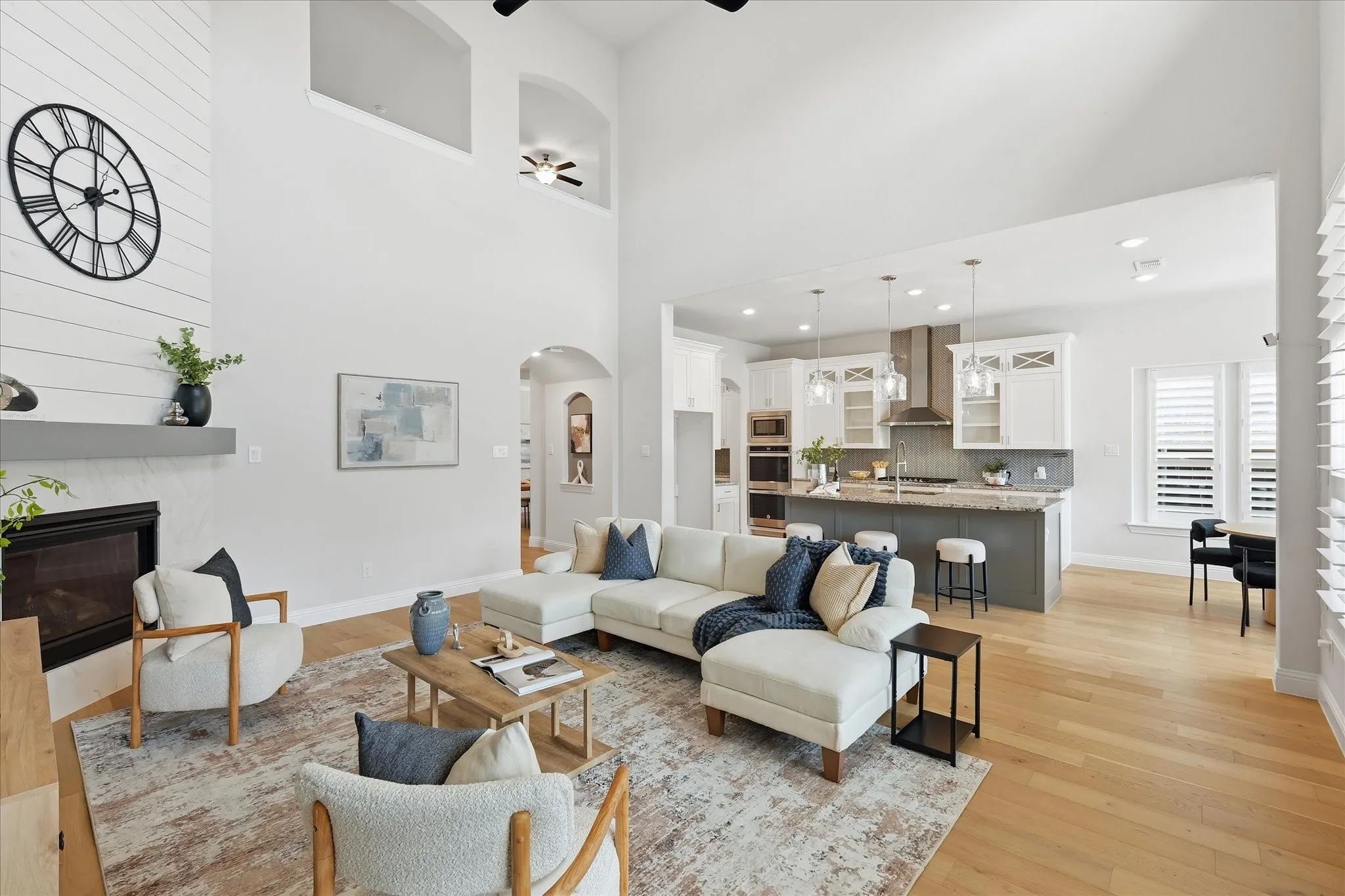 Double-height ceilings create an airy, grand feel in this main living space that flows effortlessly into the kitchen.